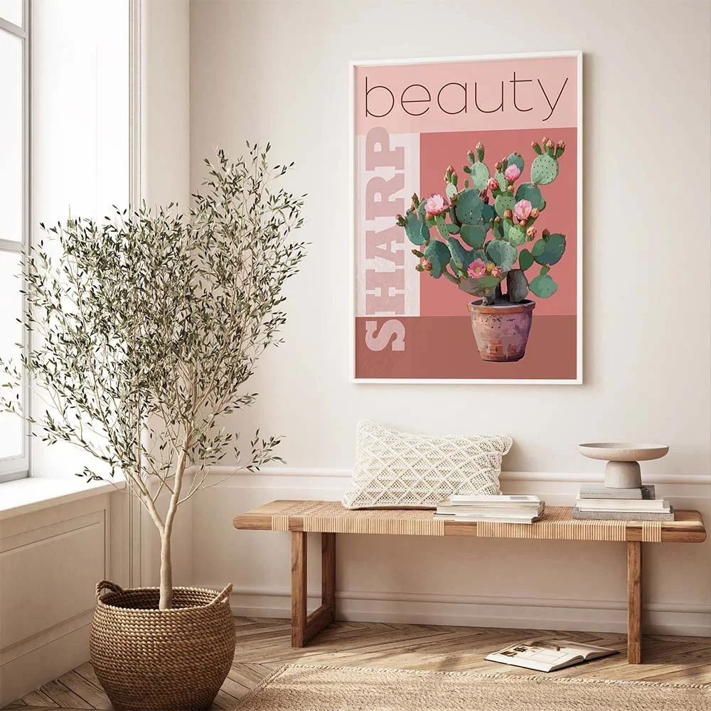 A framed art print featuring a cactus and the text "Sharp Beauty".