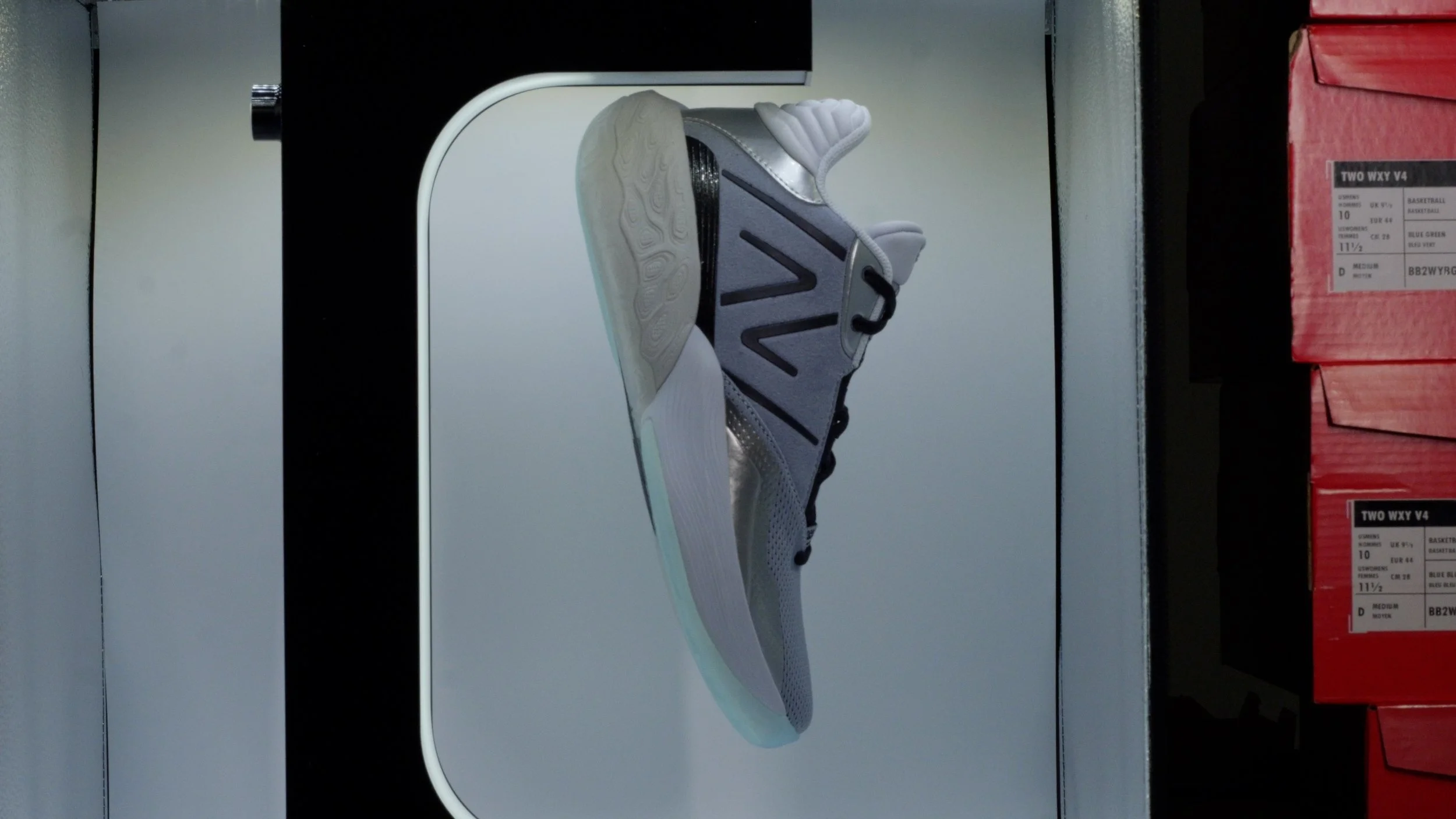 Side view of a modern athletic shoe displayed on a digital screen in a store