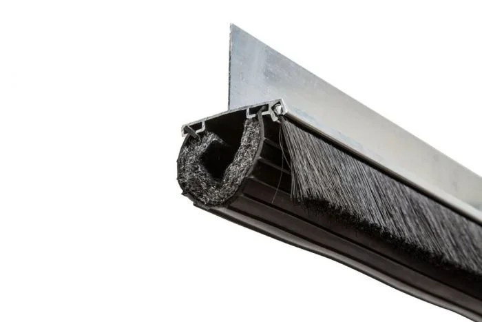 Close-up view of an aluminum retainer with brush and rodent block seal.