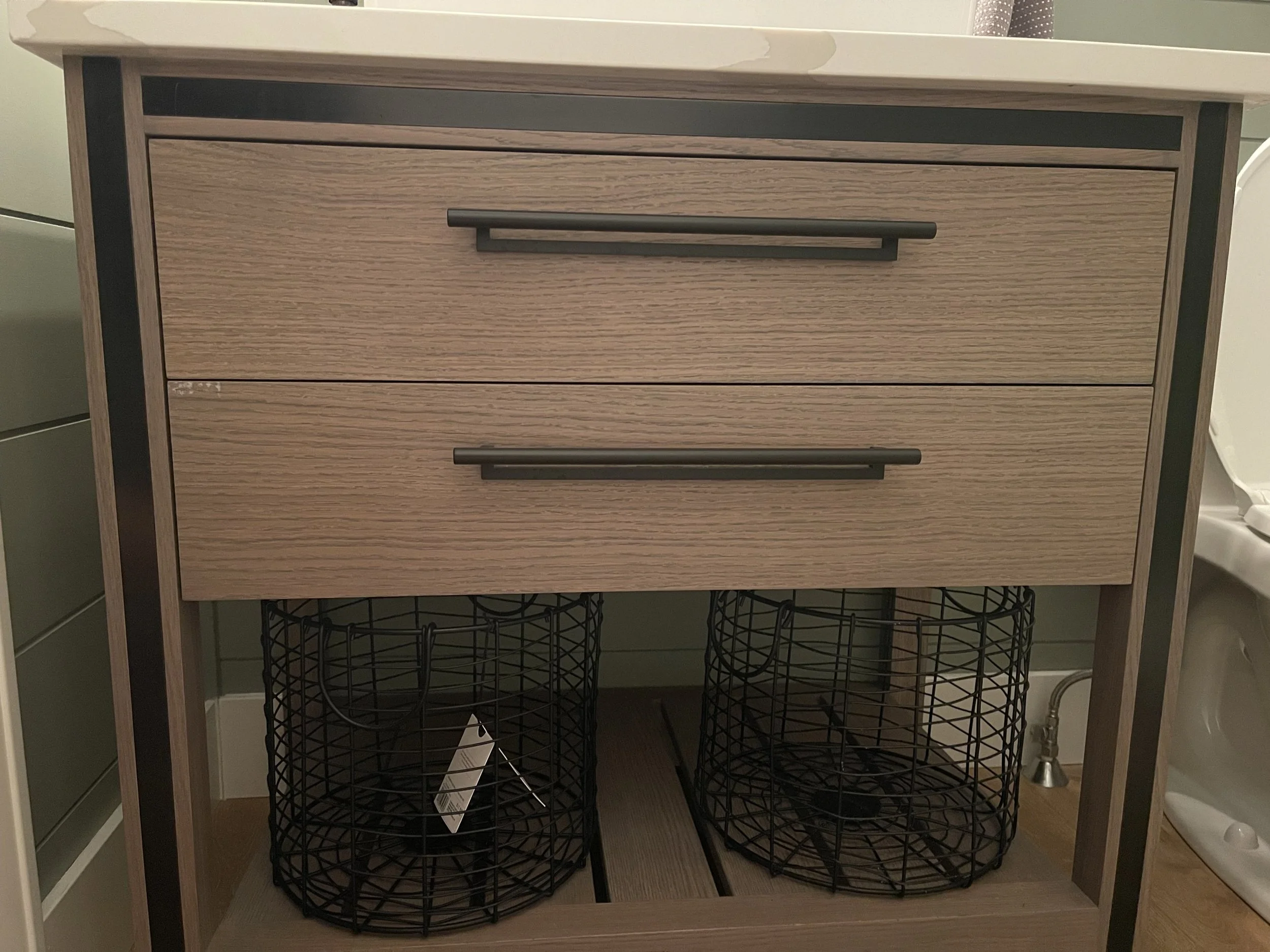Wooden bathroom vanity with storage baskets