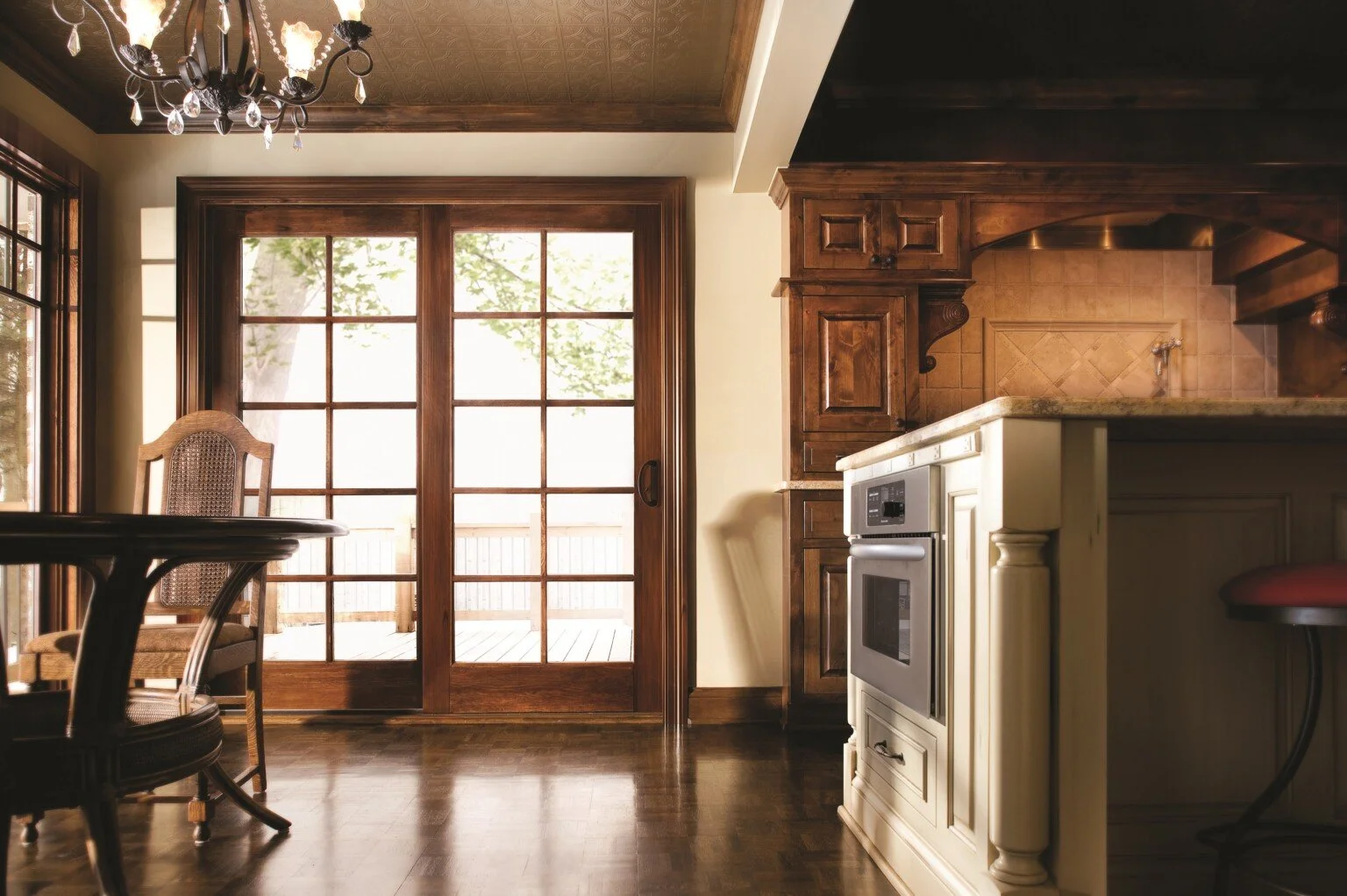 Kitchen with wooden cabinets, sliding glass doors, and a chandelier.