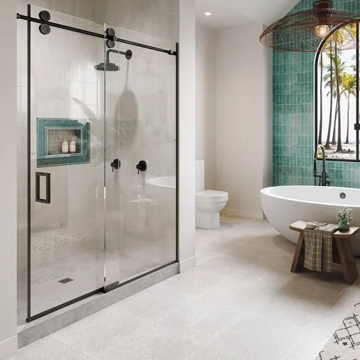 Modern bathroom with glass-enclosed shower, a freestanding bathtub, a green-tiled wall with a window showing palm trees outside, and neutral-colored flooring.