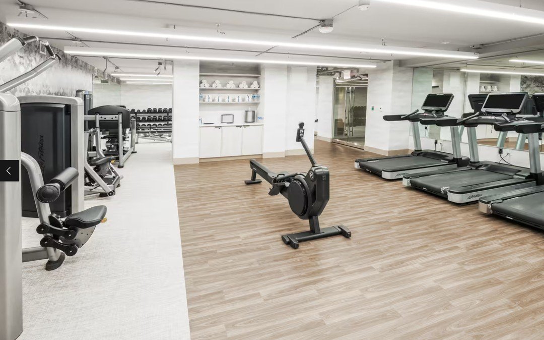 Even the smaller, less frequently used spaces deserve thoughtful design and craftsmanship. This custom millwork package for the fitness center focused on creating a clean, functional experience through integrated shelving, built-in towel and waste st