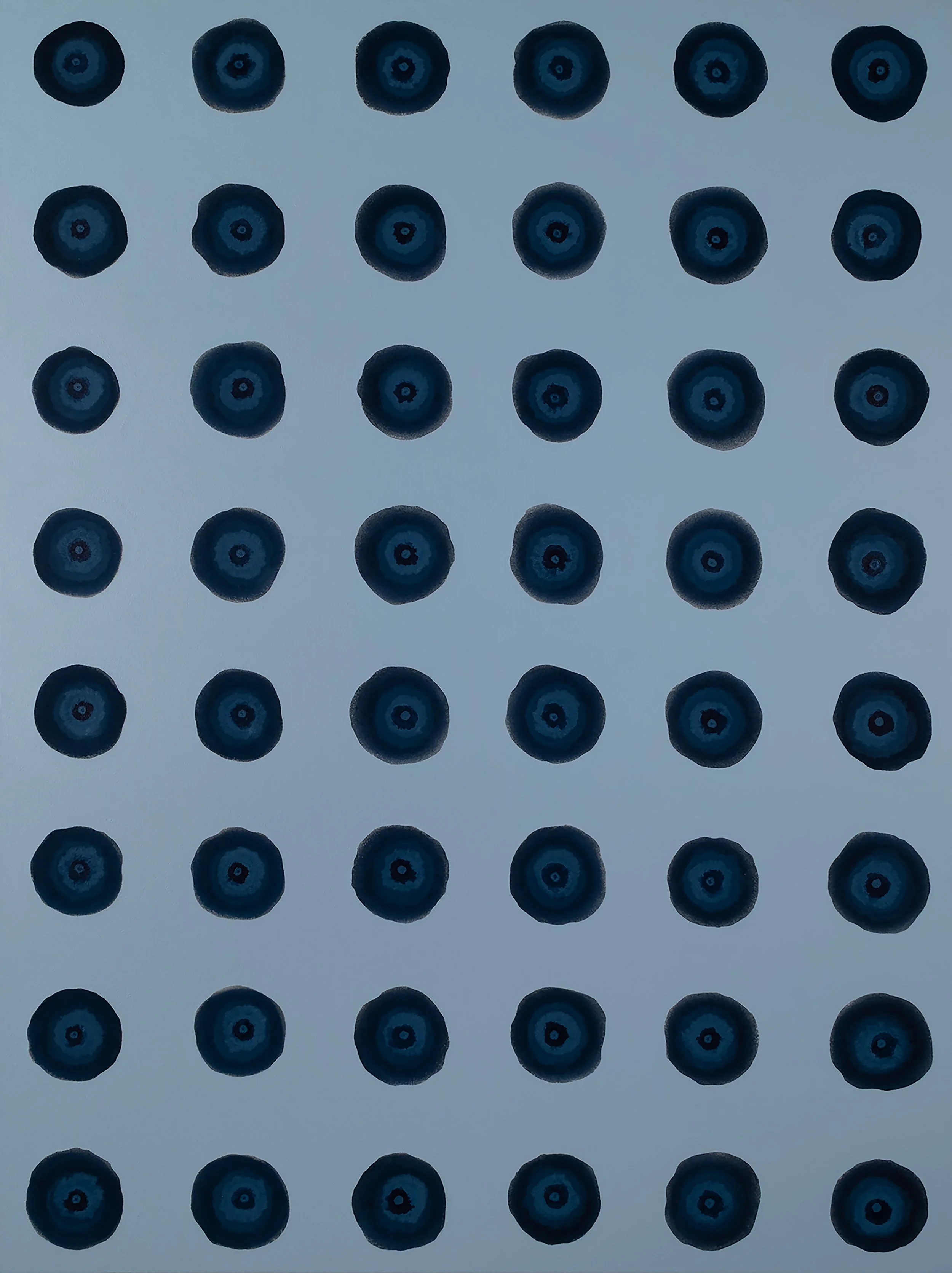 A pattern of black and blue blueberries arranged in evenly spaced rows on a light background.