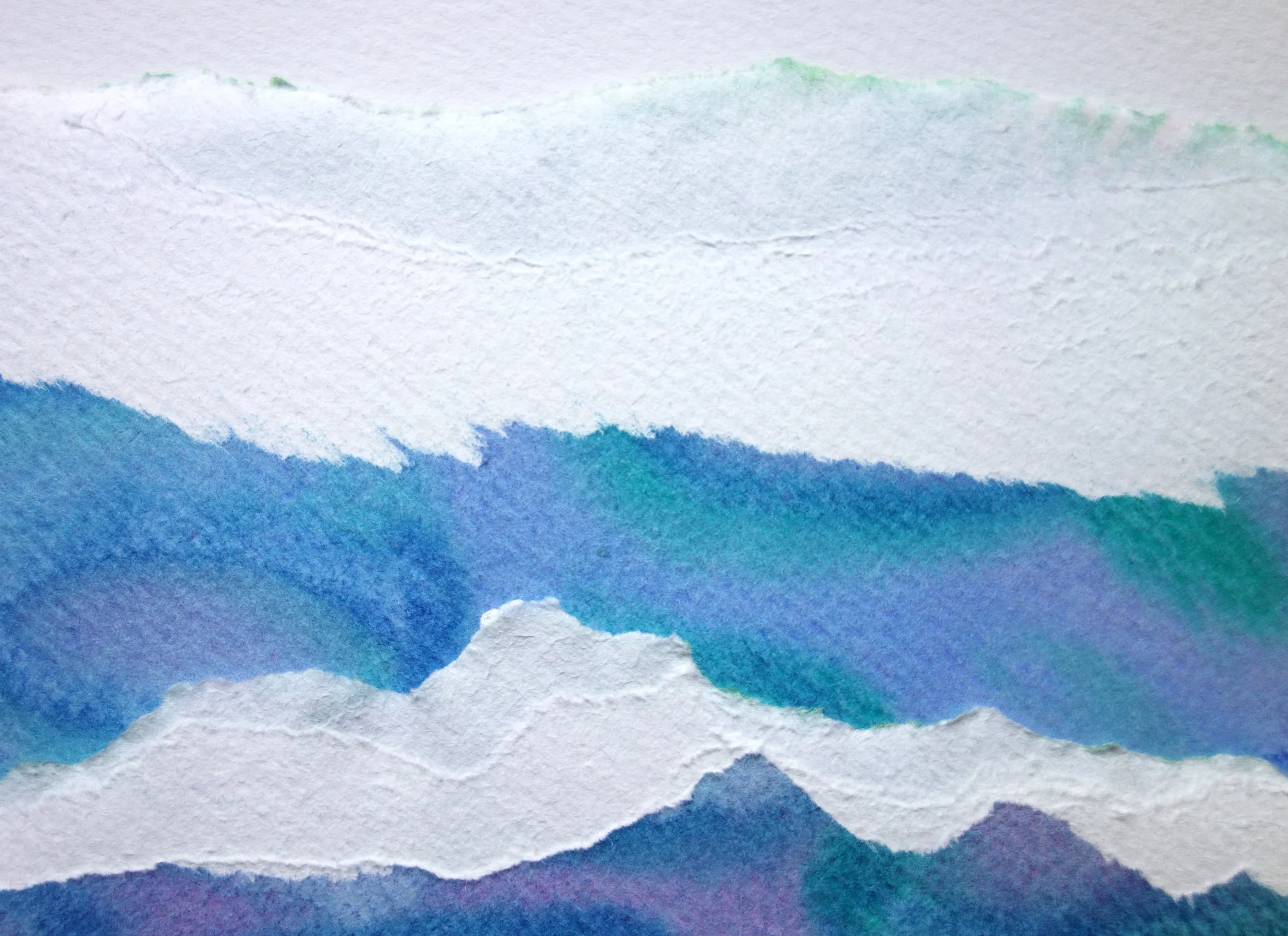Close-up of watercolor painting with layered shades of blue, purple, and white, creating an abstract landscape of mountains and sky.