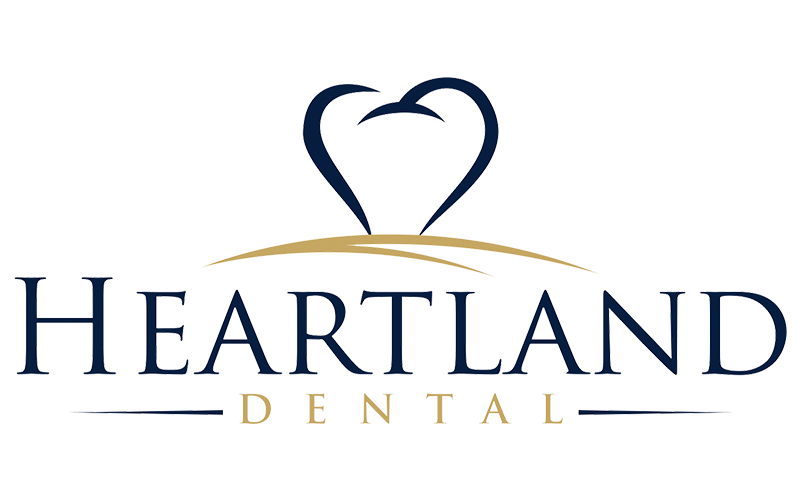 Logo for Heartland Dental featuring a stylized heart shape with a toothbrush handle, and the company name in dark blue and gold lettering.