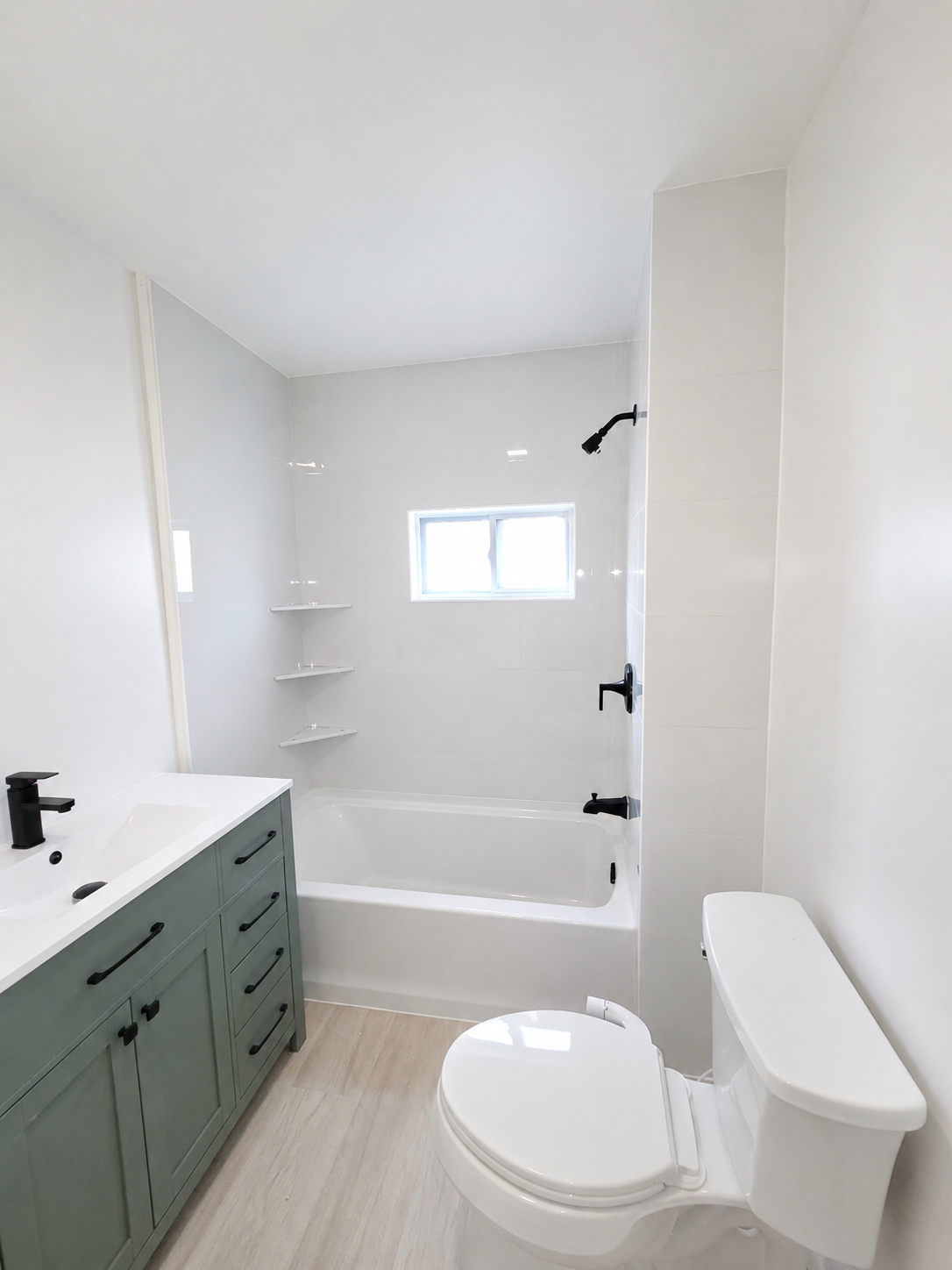 A freshly remodeled bathroom tub with a white tiled surround. Muskegon, MI.

