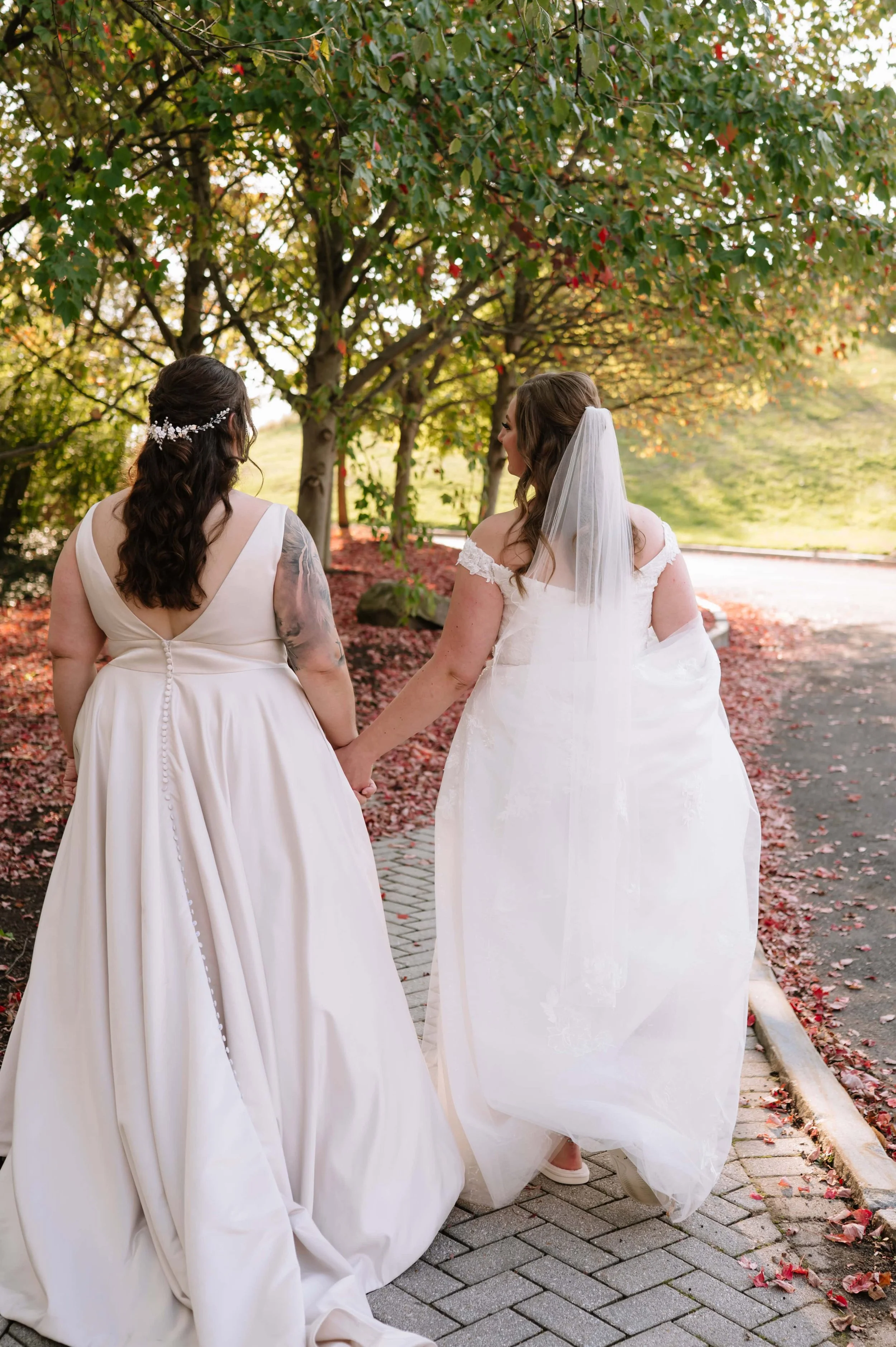 brides walking in fallen leaves.jpg