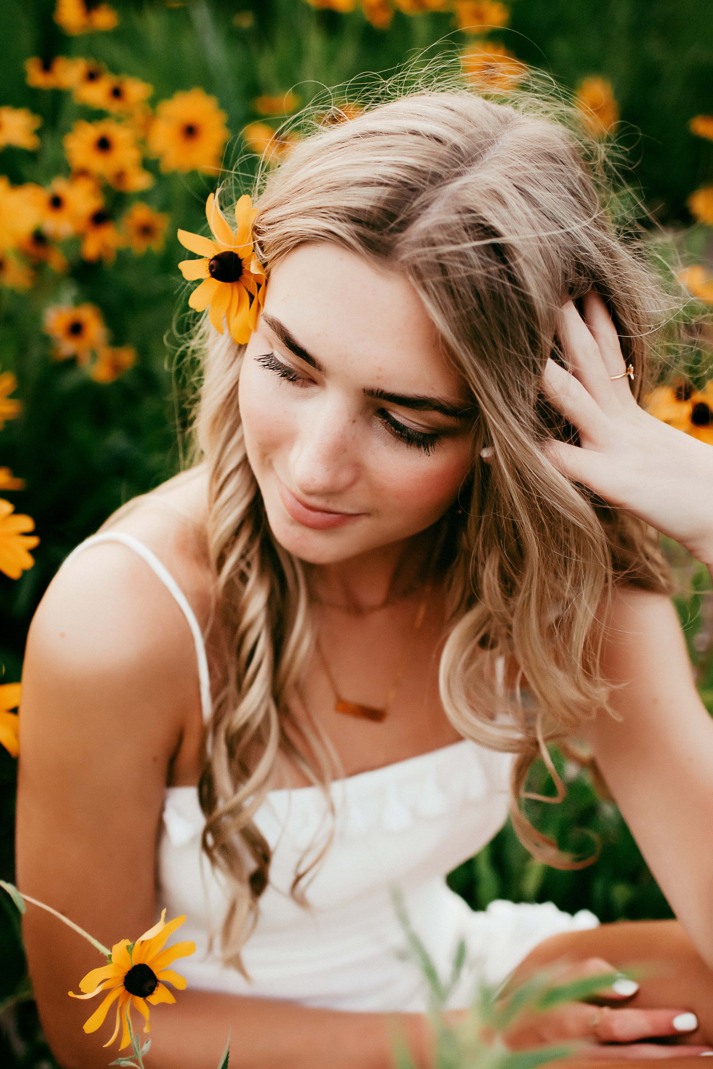 high school girl posing with flowers in her hair