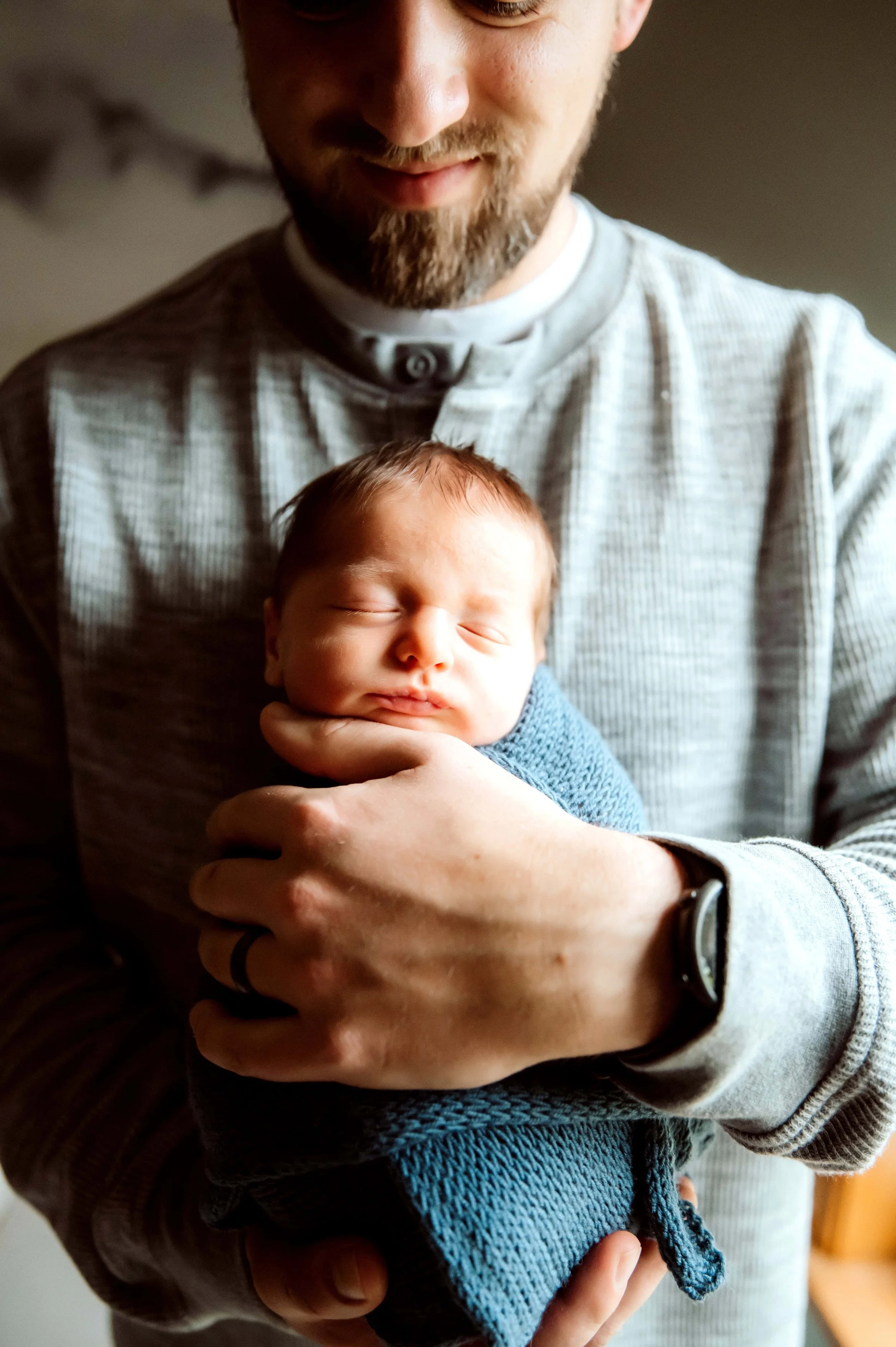 dad holding new baby boy