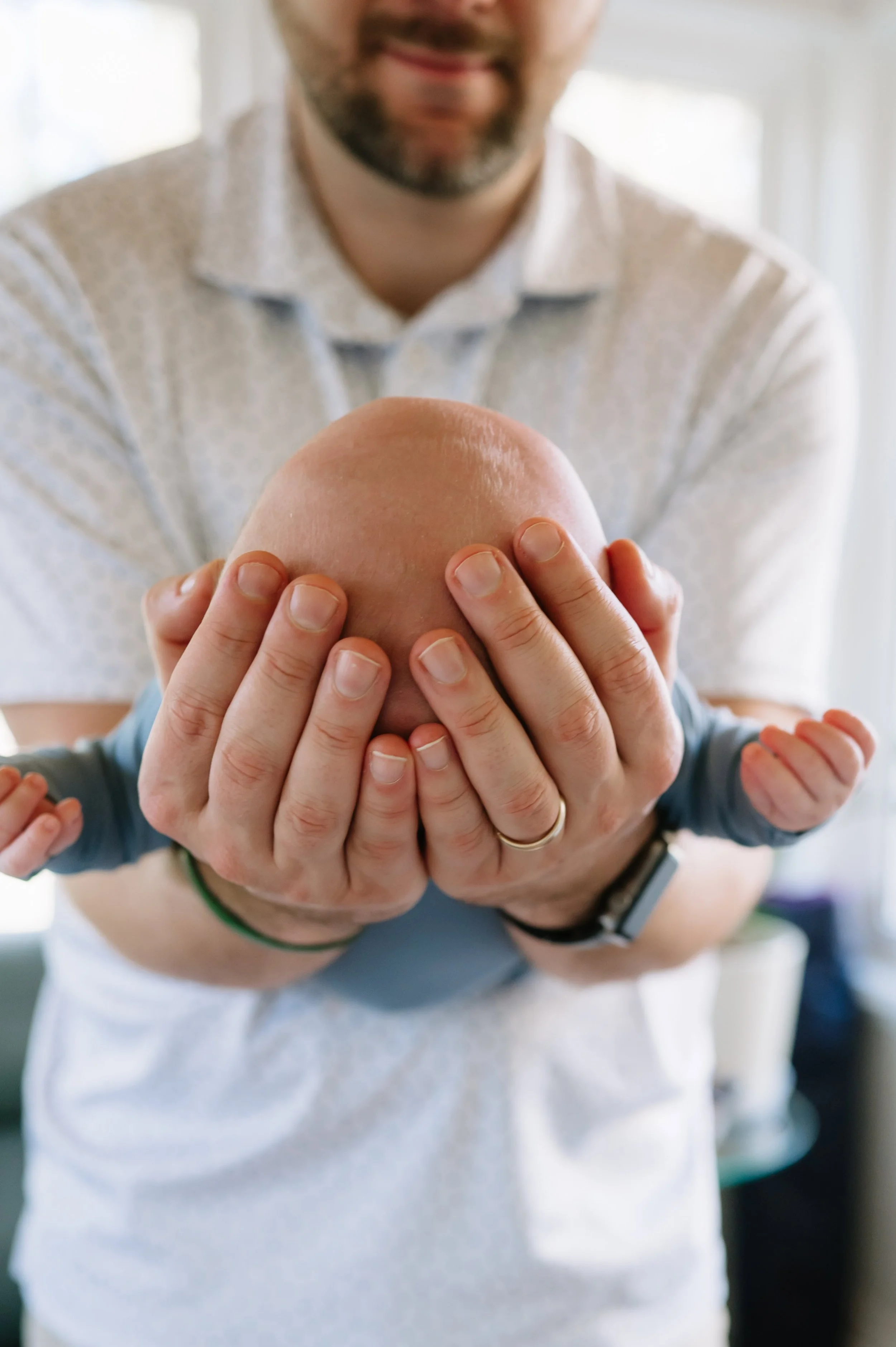 dad holding newborn baby