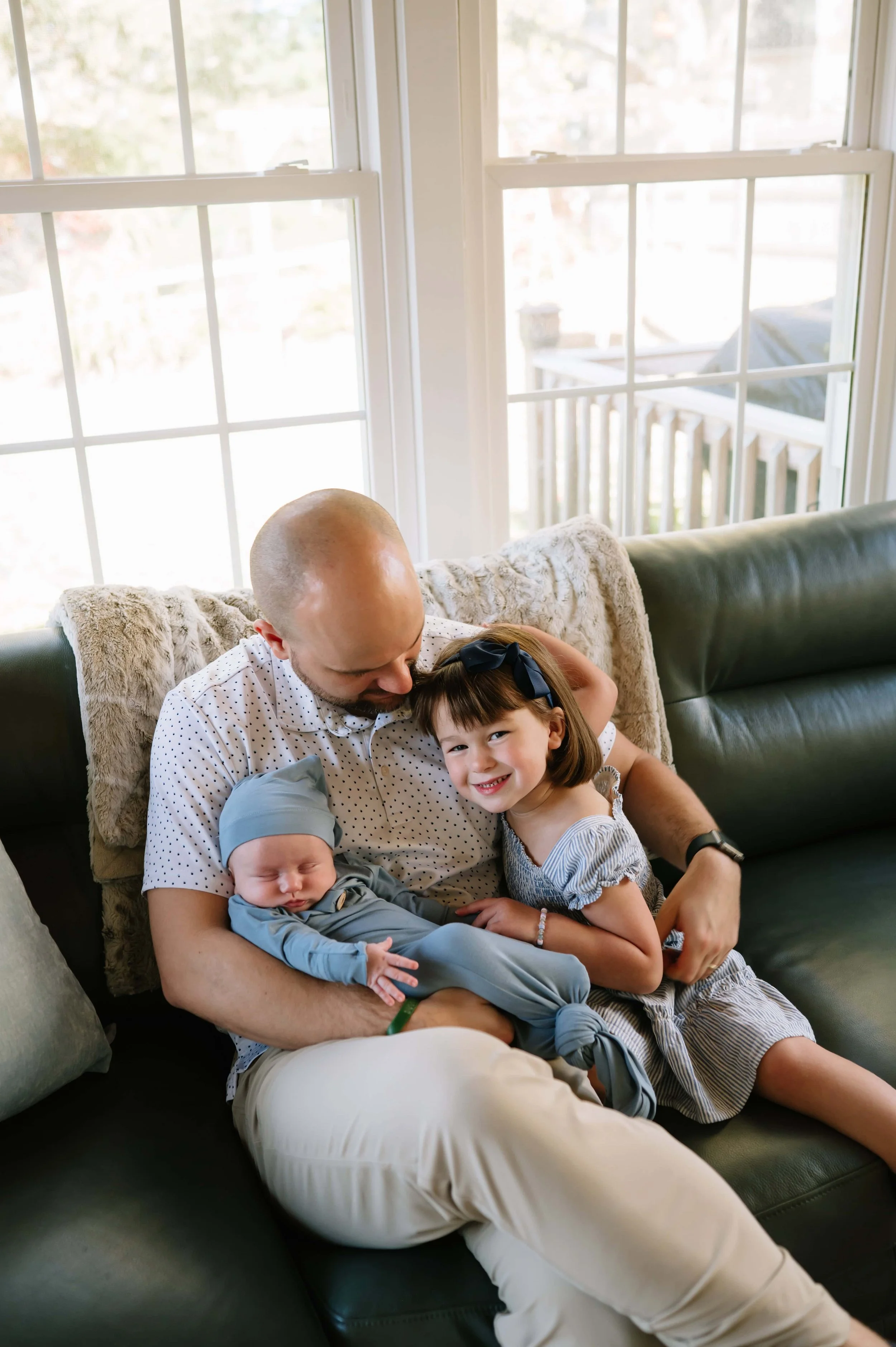 dad holding babies during newborn photos