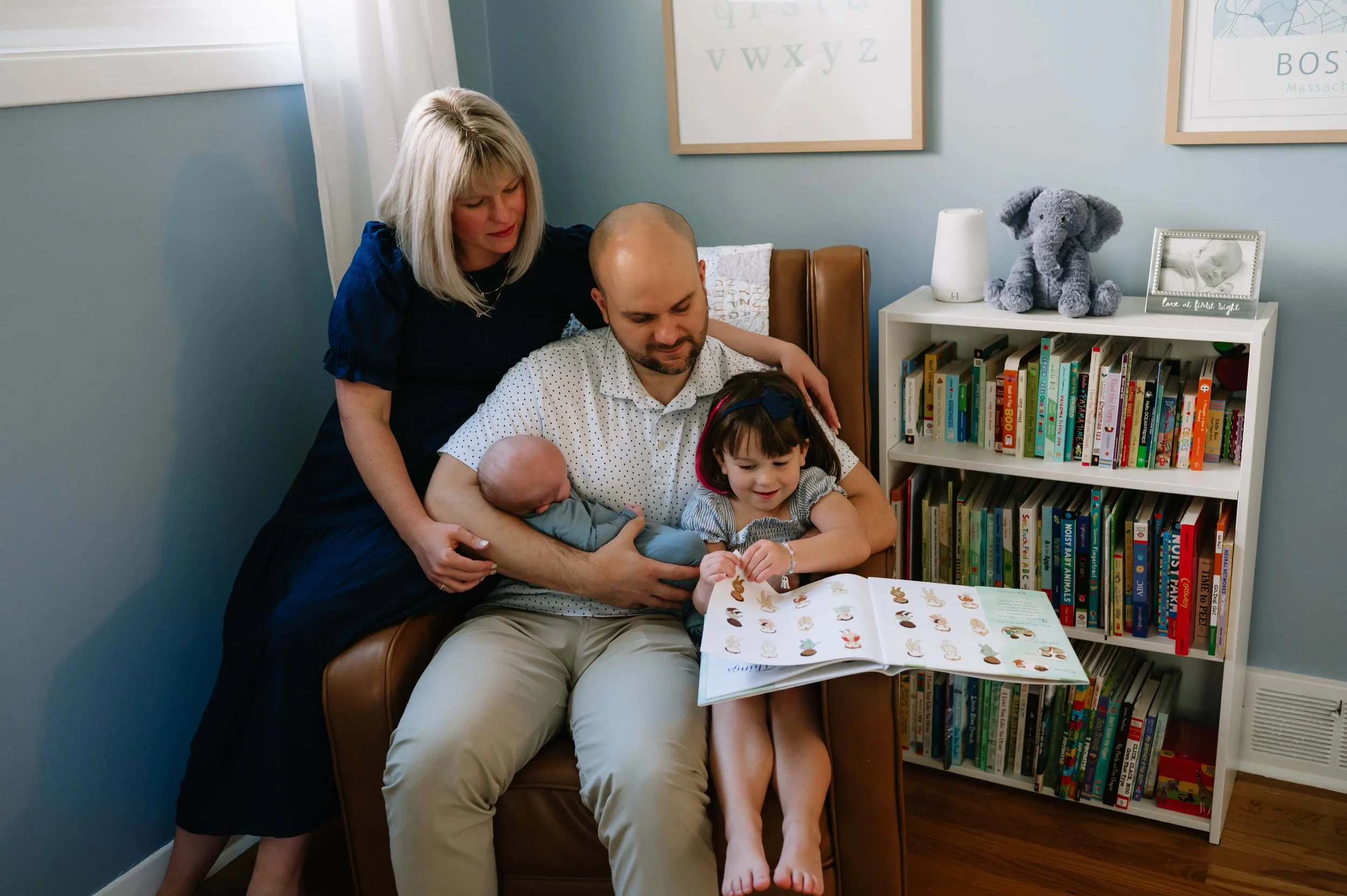 family reading in nursery during photos
