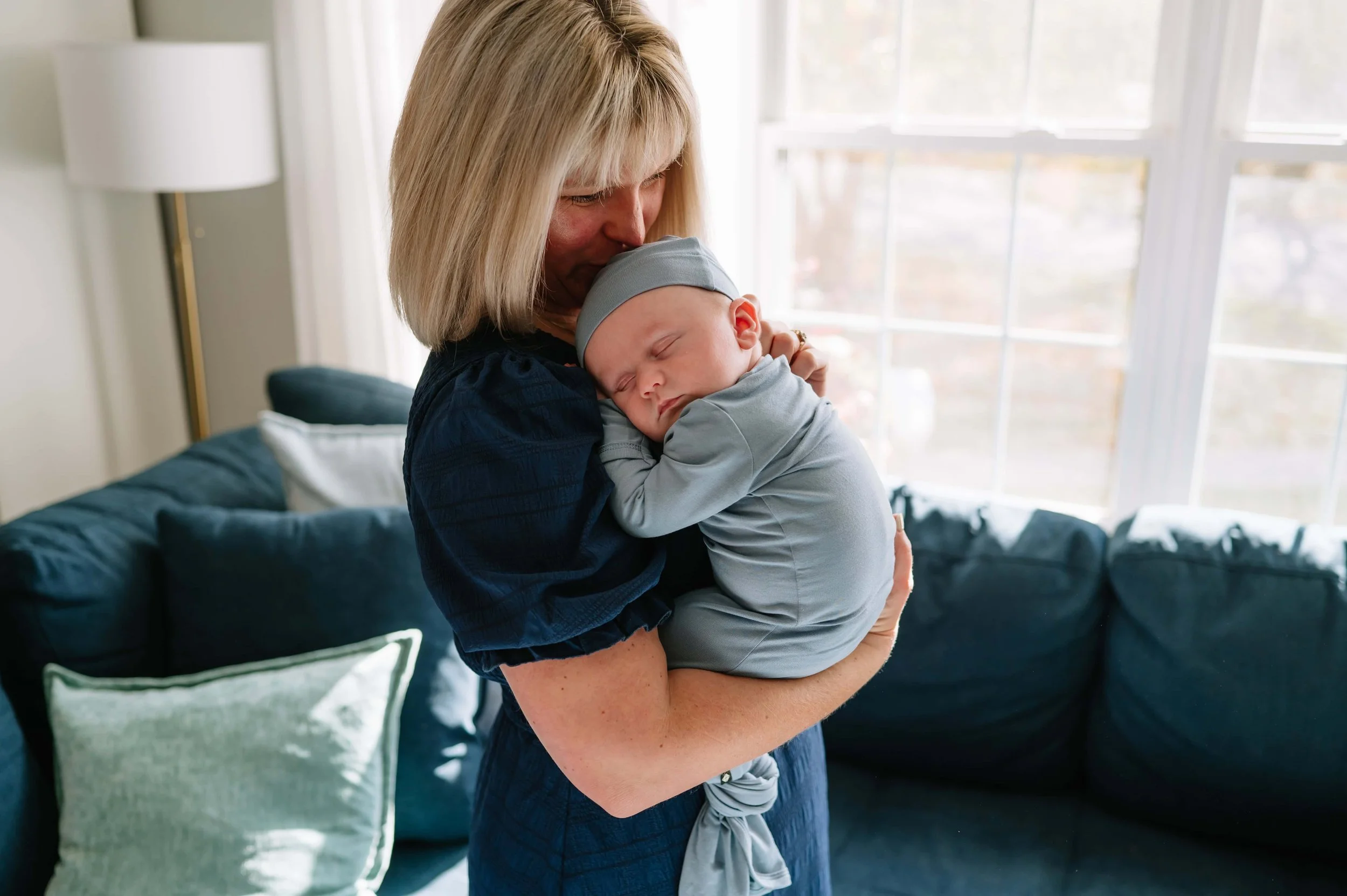 mom holding newborn during photos