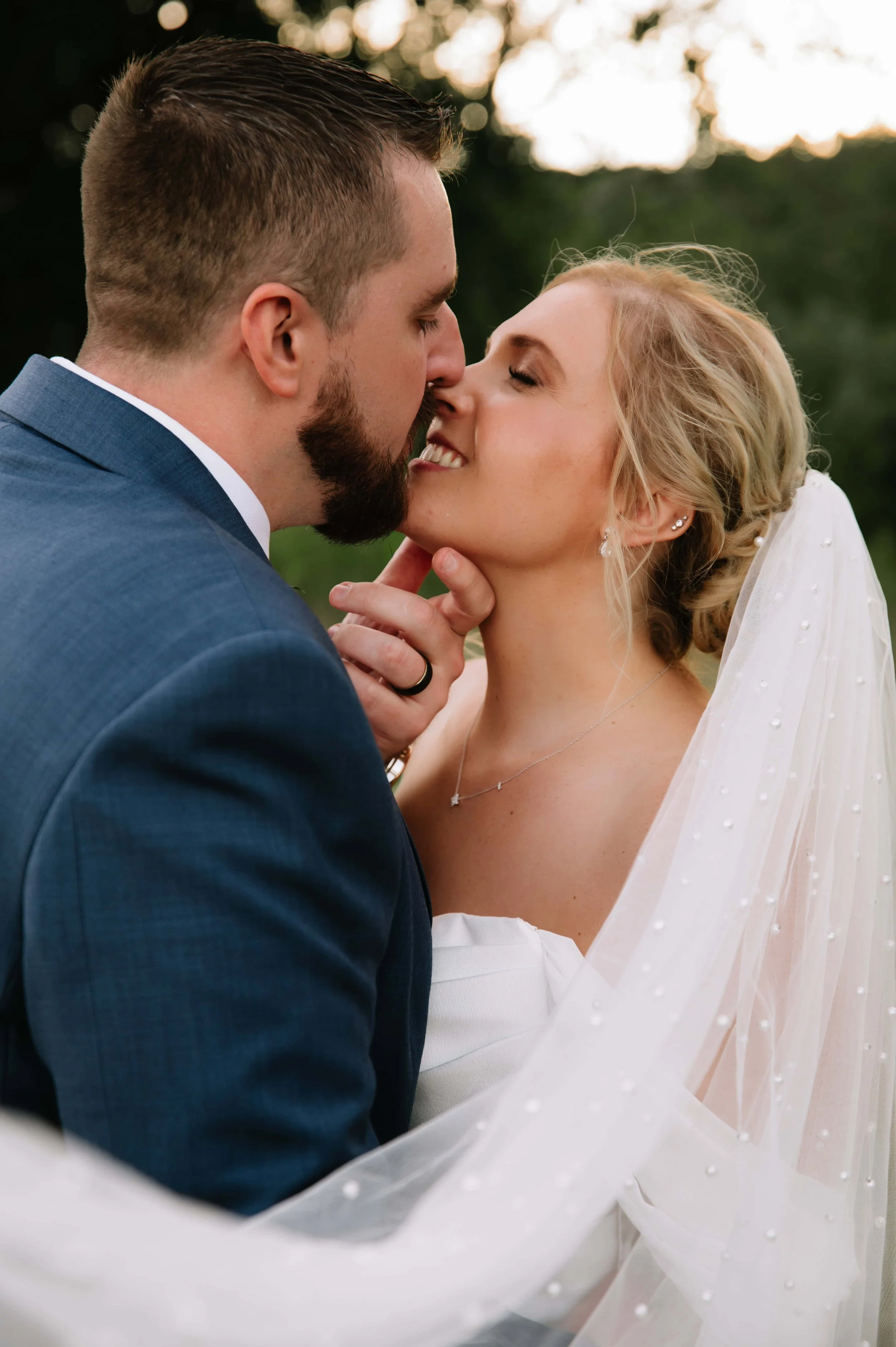 bride kissing groom during photos