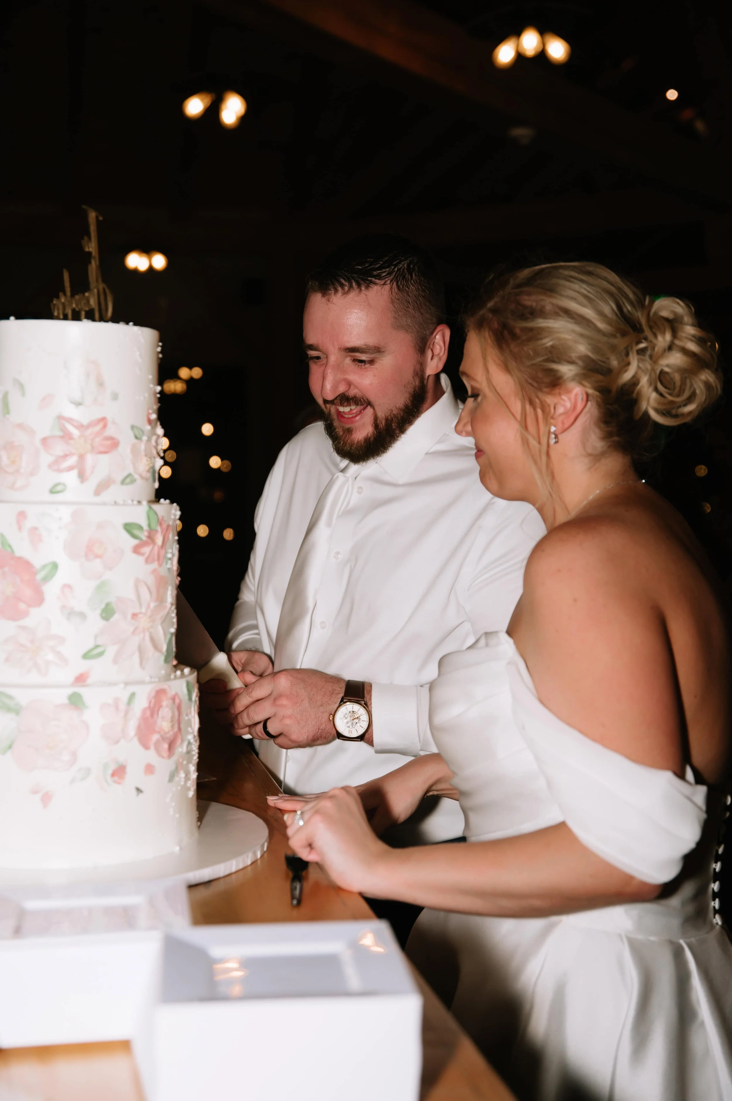 wedding couple cutting cake during reception