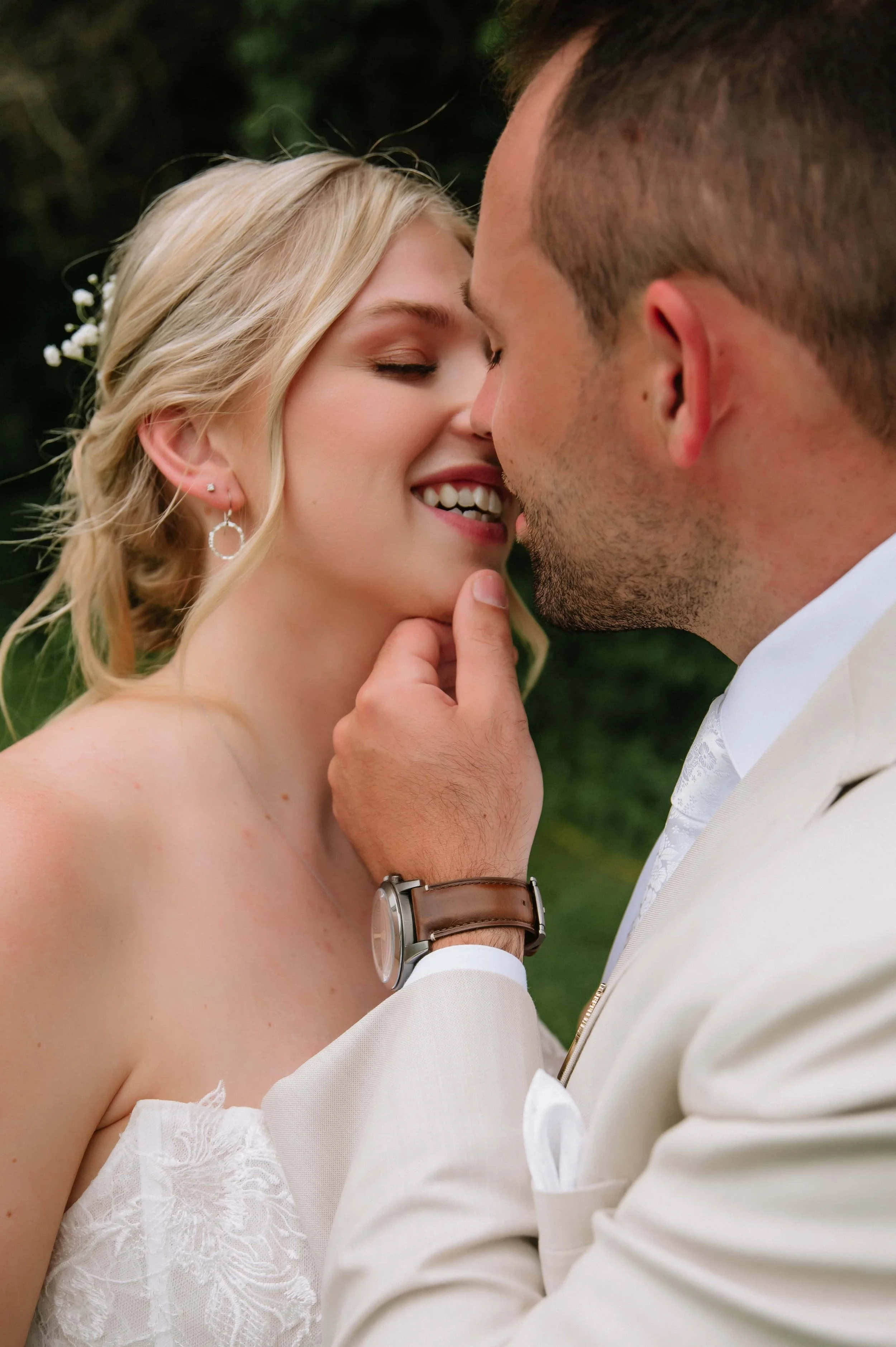 groom kissing bride outdoor wedding.jpg