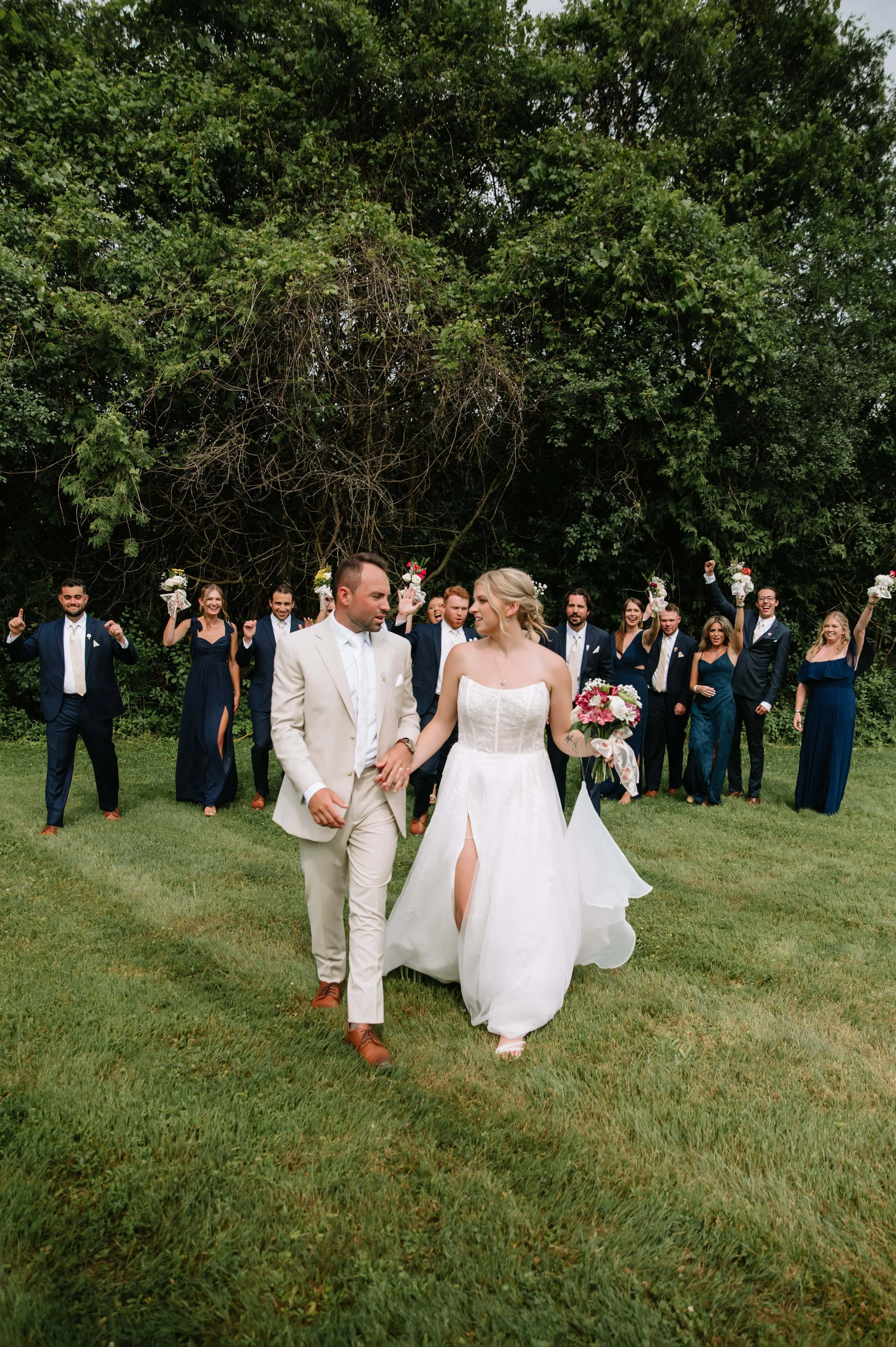 bride and groom walking with bridal party.jpg