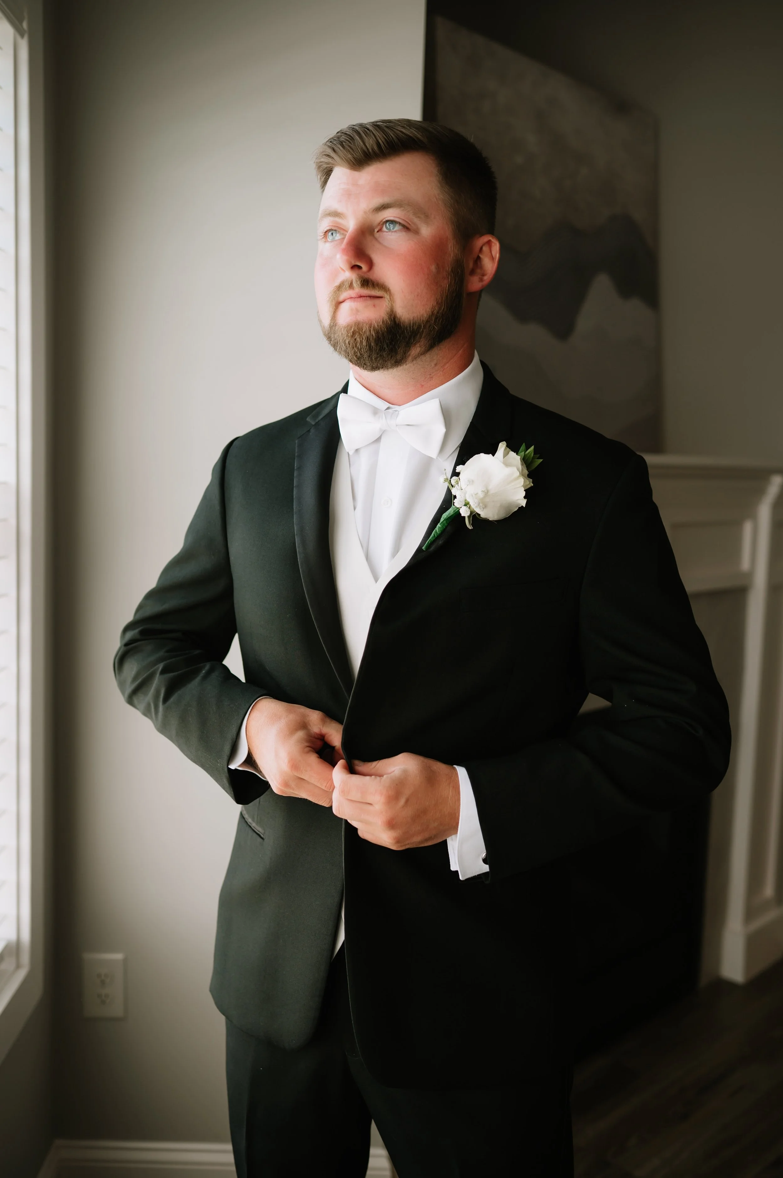 groom buttoning jacket.jpg