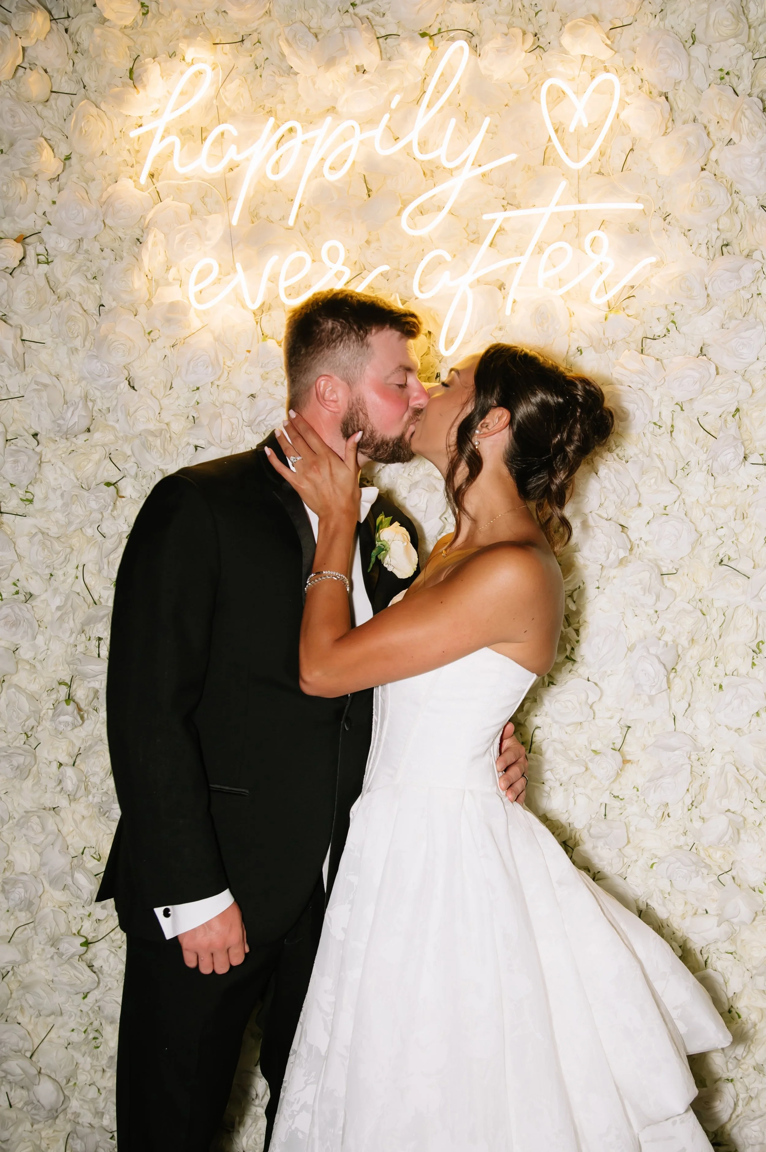 couple in front of photo wall.jpg