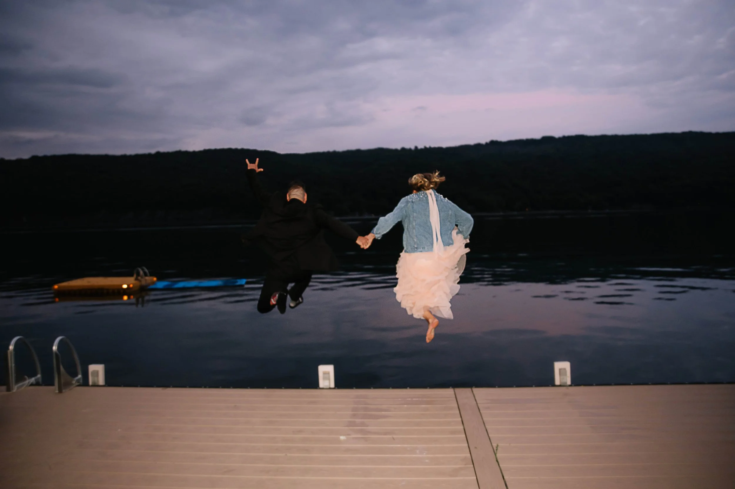 bride and groom jumping into lake.jpg