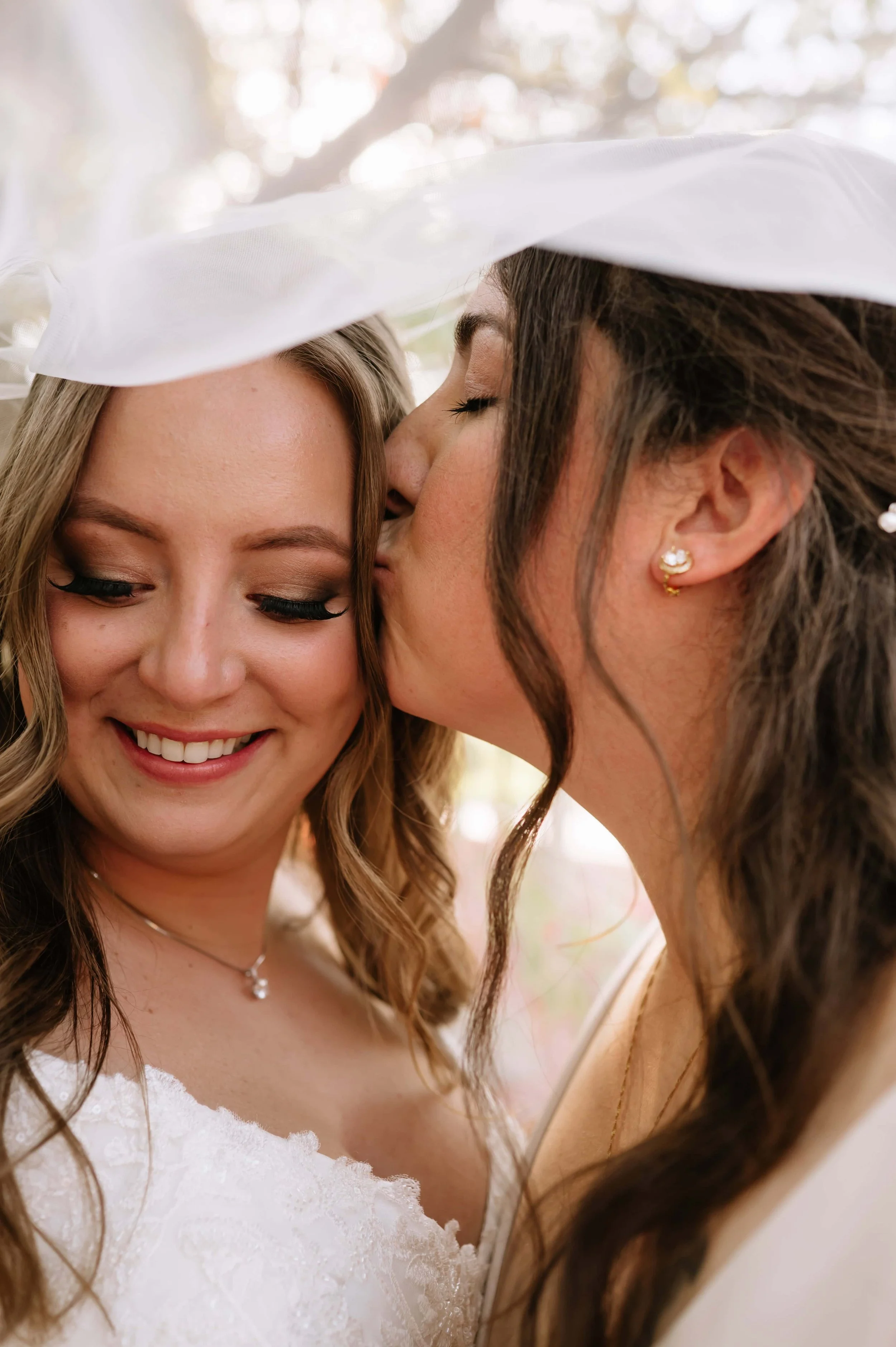 bride giving her bride a kiss.jpg