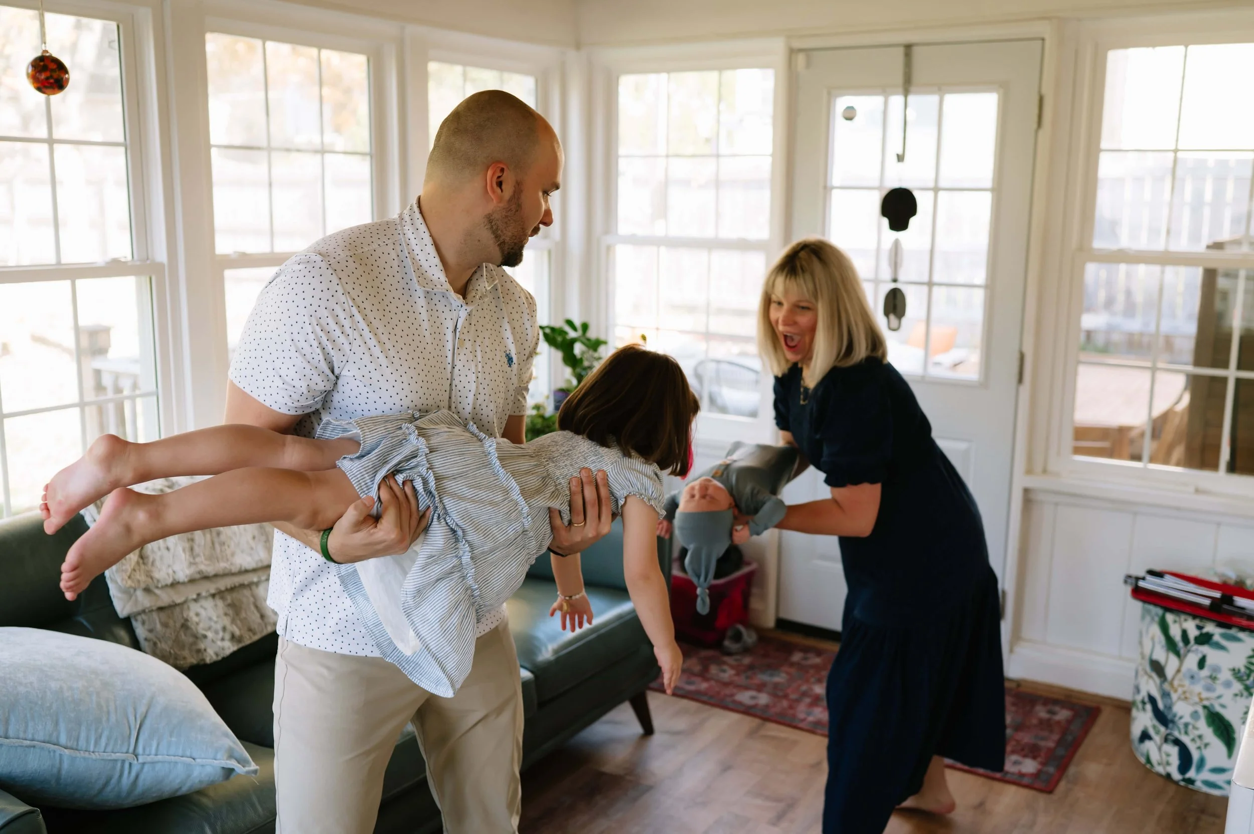 family laughing during newborn photography session