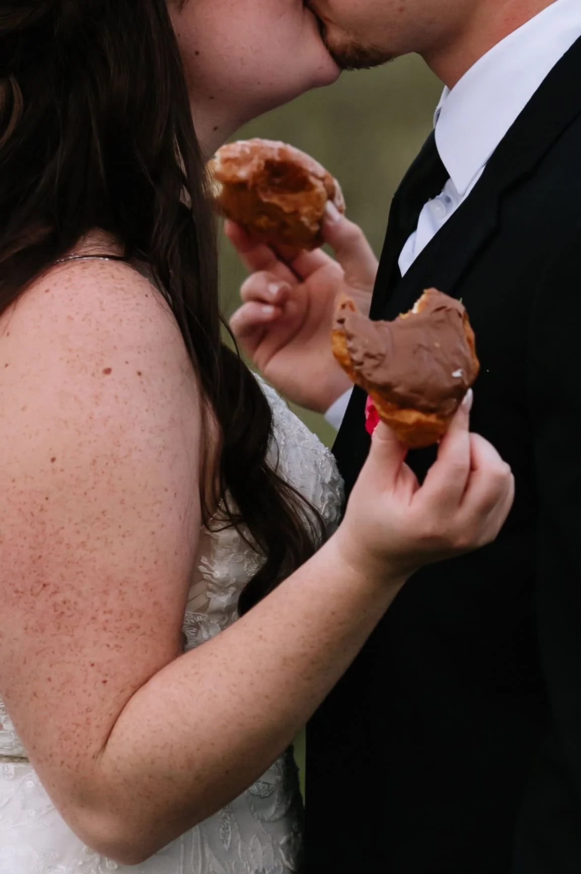 couple eating donuts at wedding.jpg