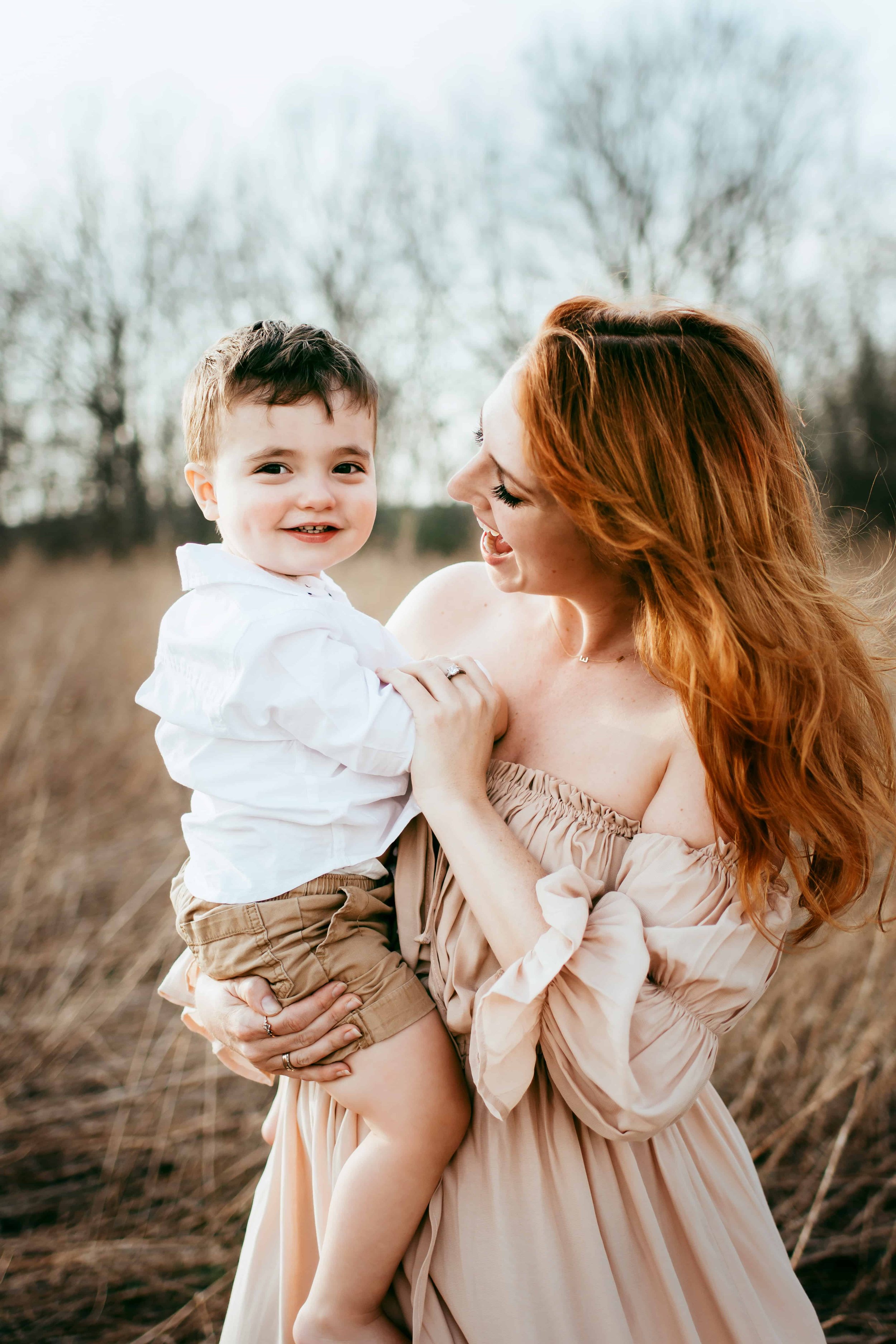 Mother and son dancing in a field during spring in syracuse
