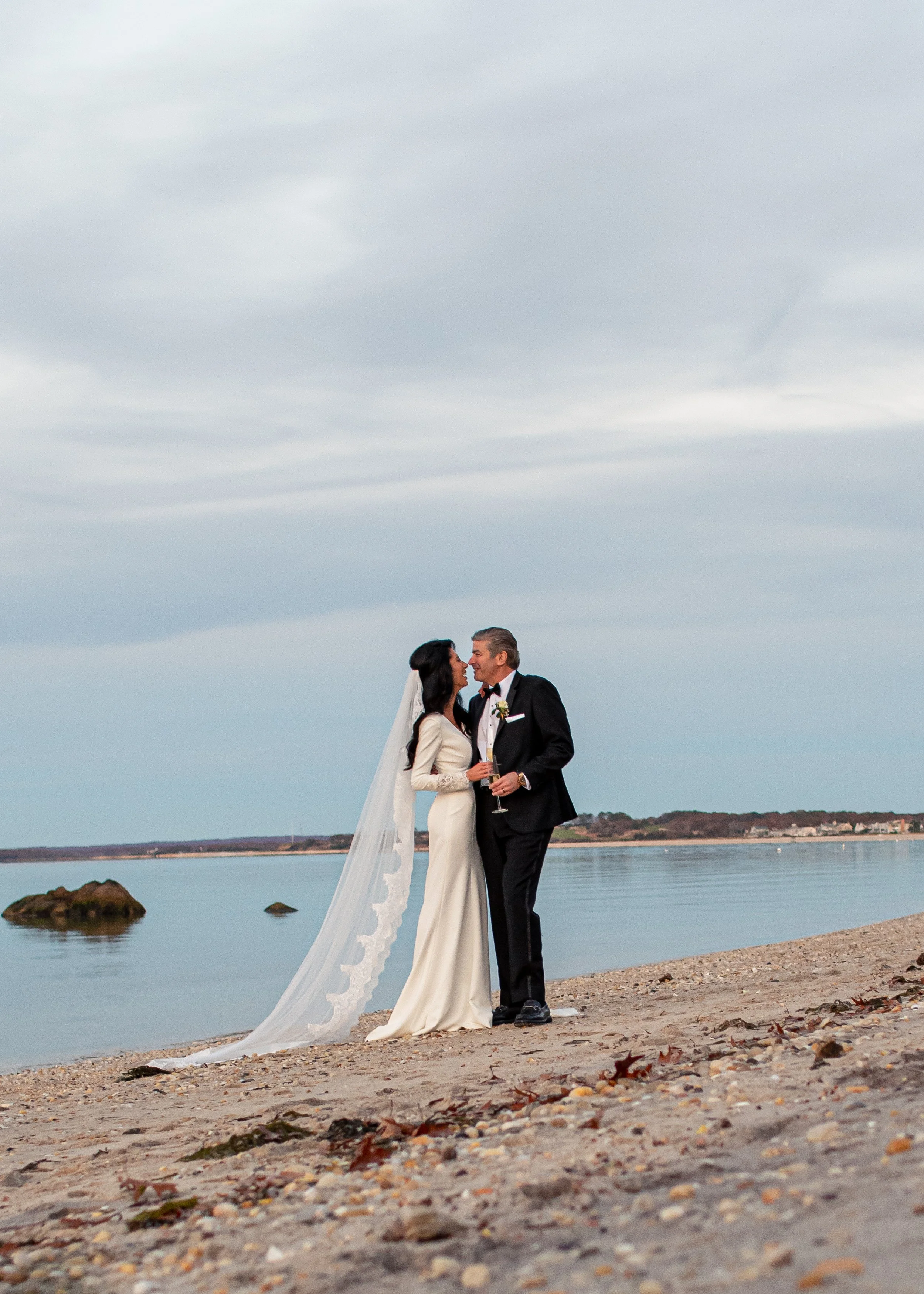 The couple shares a heartfelt kiss by the ocean’s edge, their love framed against sweeping waves and endless sky.
Romantic, timeless, and uniquely New York—captured by a leading wedding photographer in the USA.