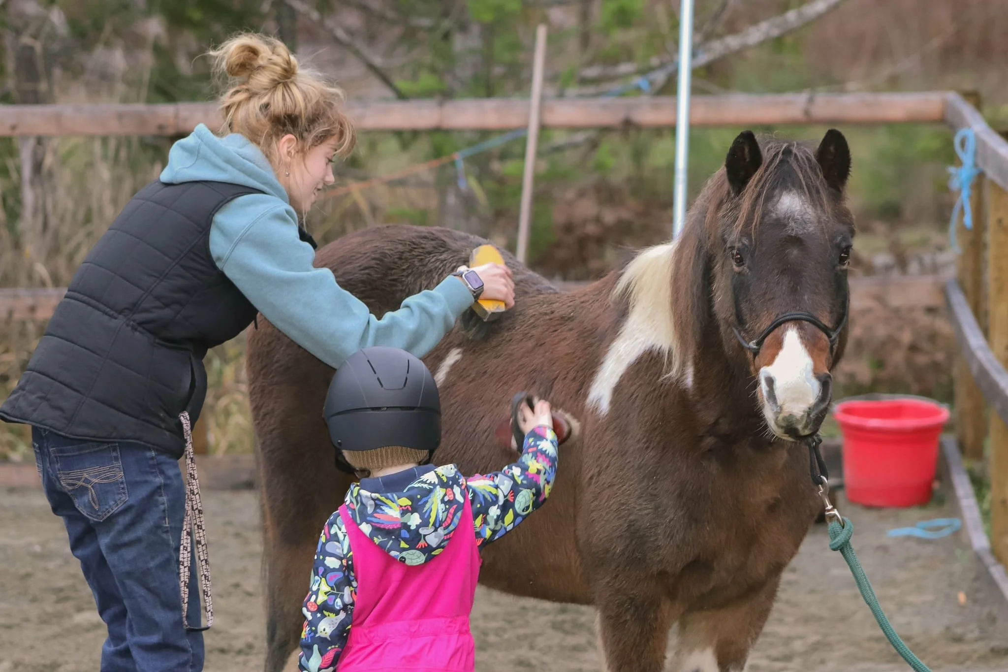 girl standing head to head with horse