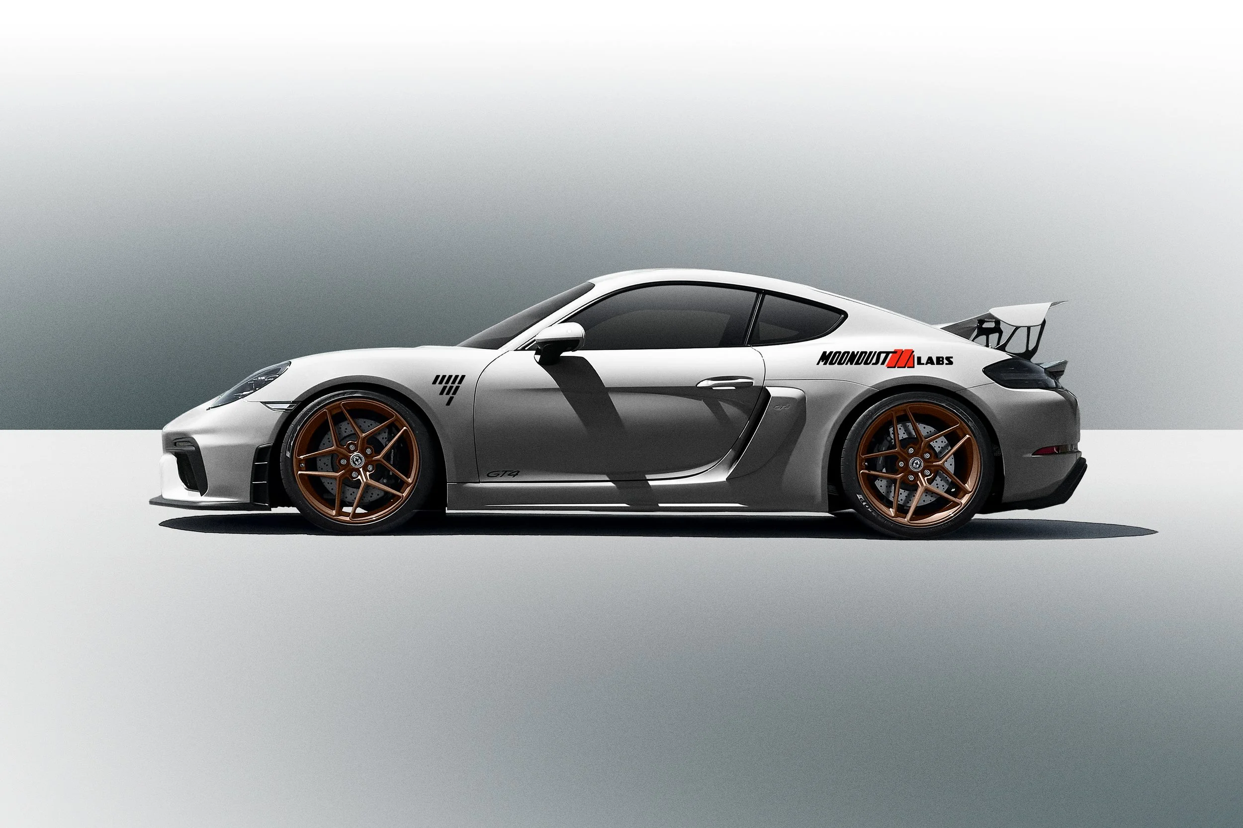 A white Porsche GT4 sports car with black accents and bronze wheels, featuring a aerodynamic rear wing, is parked on a light gray surface against a gradient background. The car has a decal reading 'MOONDUST LABS' near the rear window.