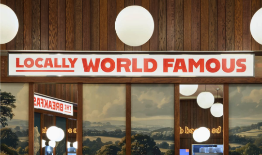 Sign reading 'Locally World Famous' with wooden wall and round white light fixtures