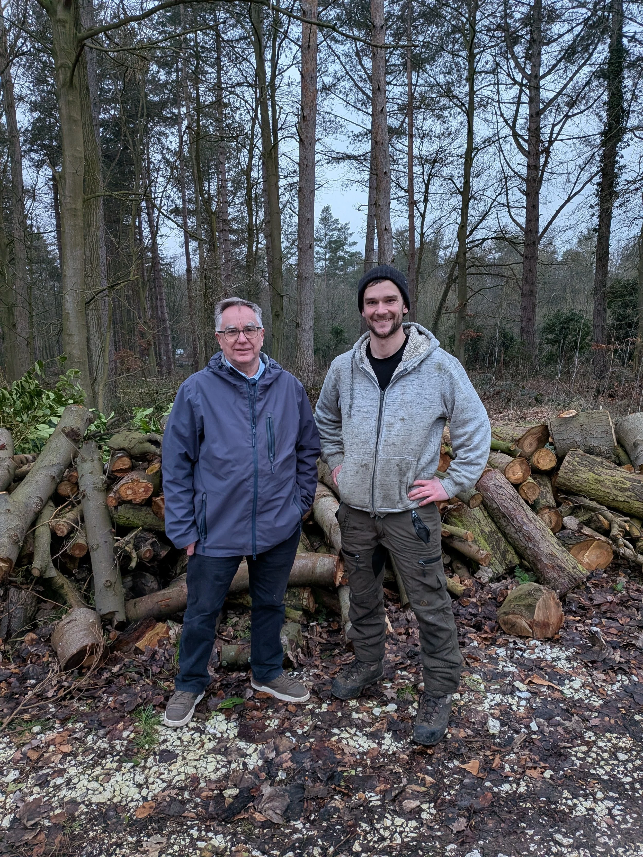 Gus Bishop and Kevin Secretary of East Yorkshire Woodturners standing with donated arb logs for sustainable woodworking.