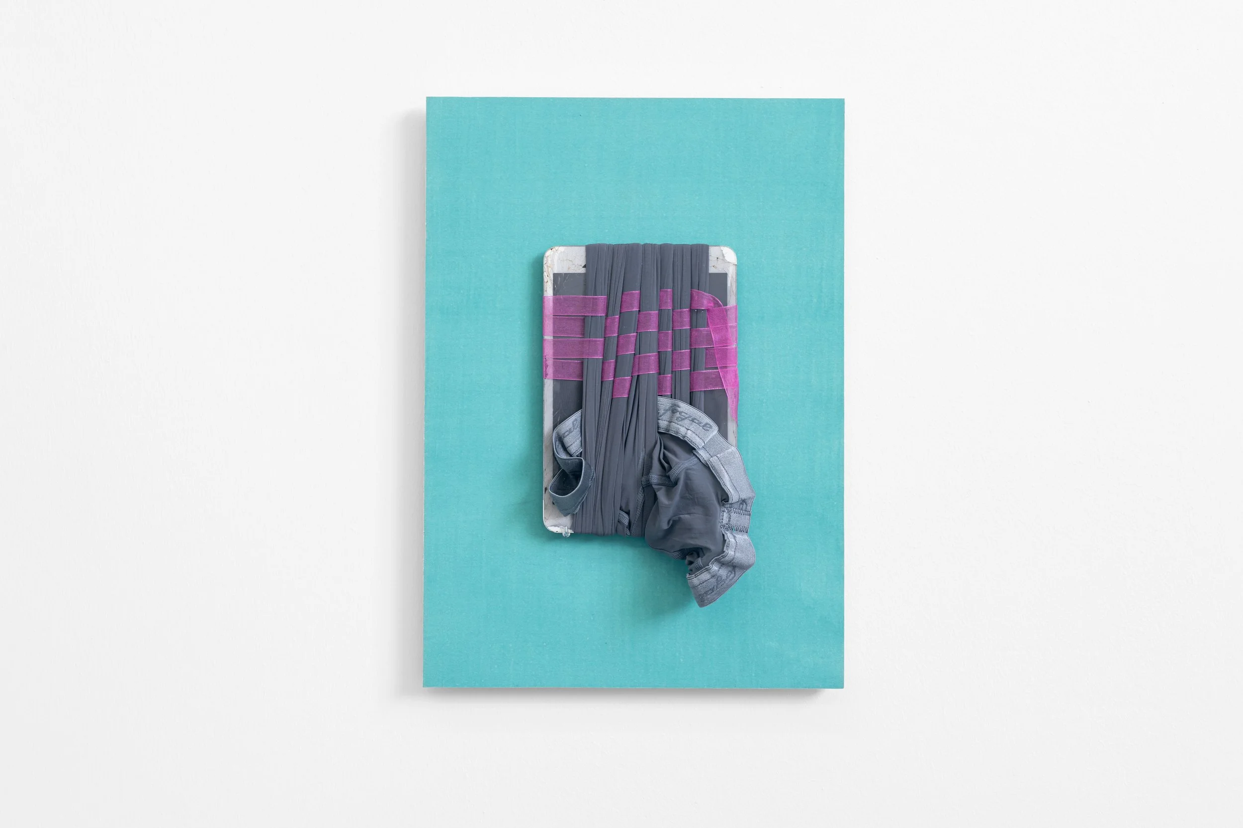 'Relic with Yoyo's tights no.1', 2026, ribbon, tights, broken iPad, hand-dyed paper mounted on board, 42 x 29.5 x 3 cm