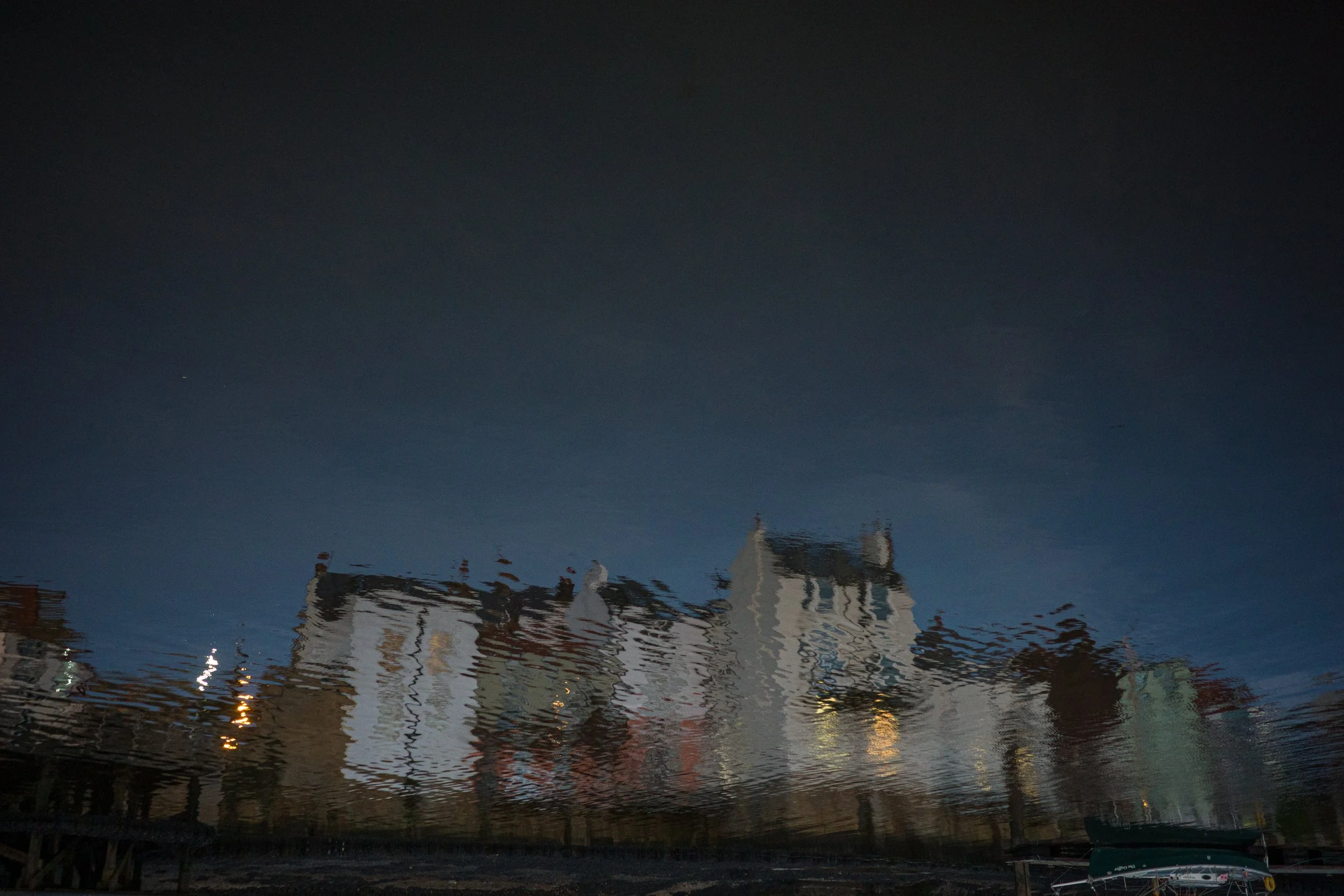 Reflection of buildings on water at night.