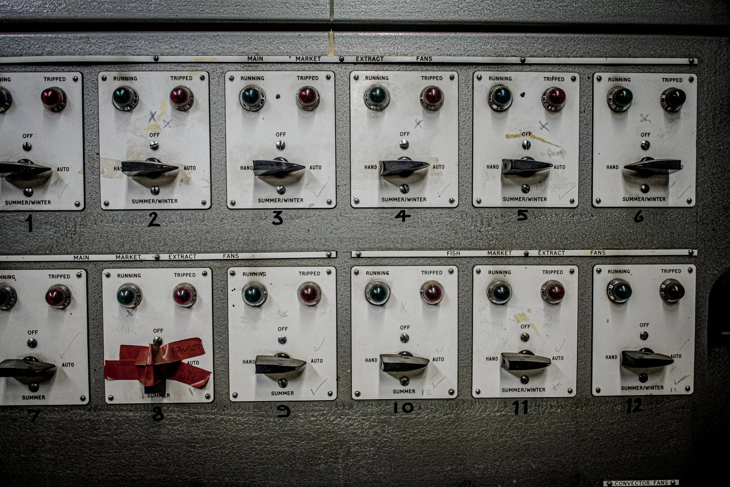 Electrical control panels with switches and lights labeled for different functions and seasons.