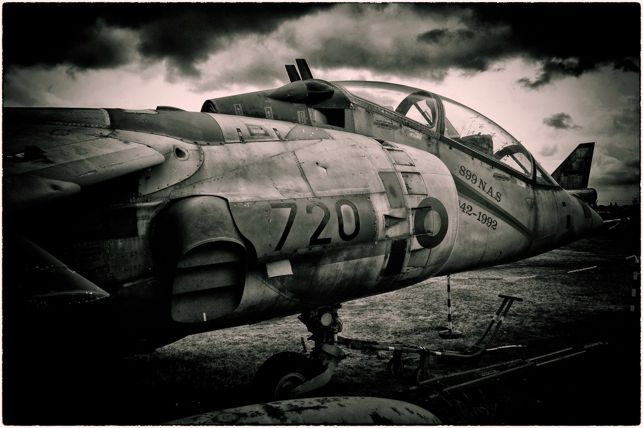 Close-up of a military fighter jet aircraft with a cloudy sky in the background.