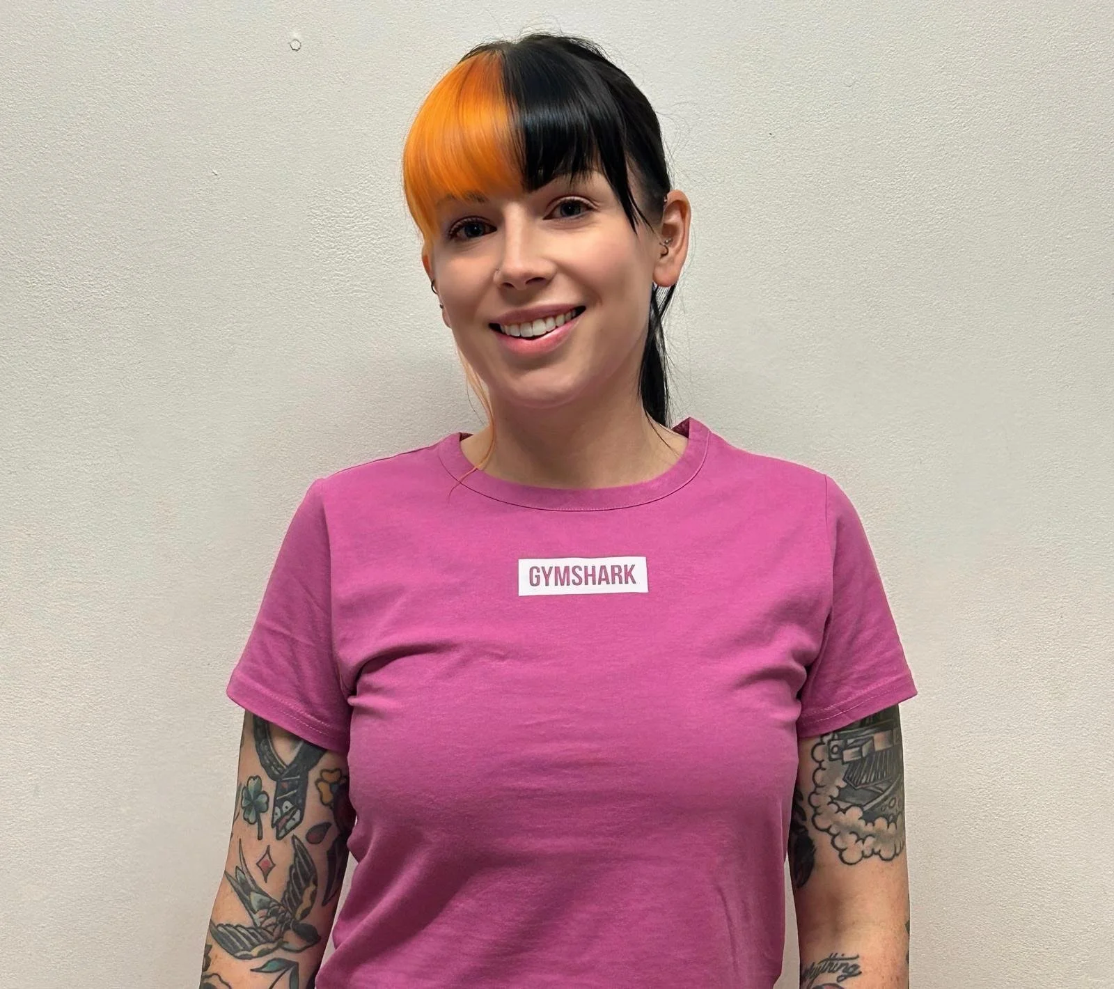 Female in pink t-shirt smiling