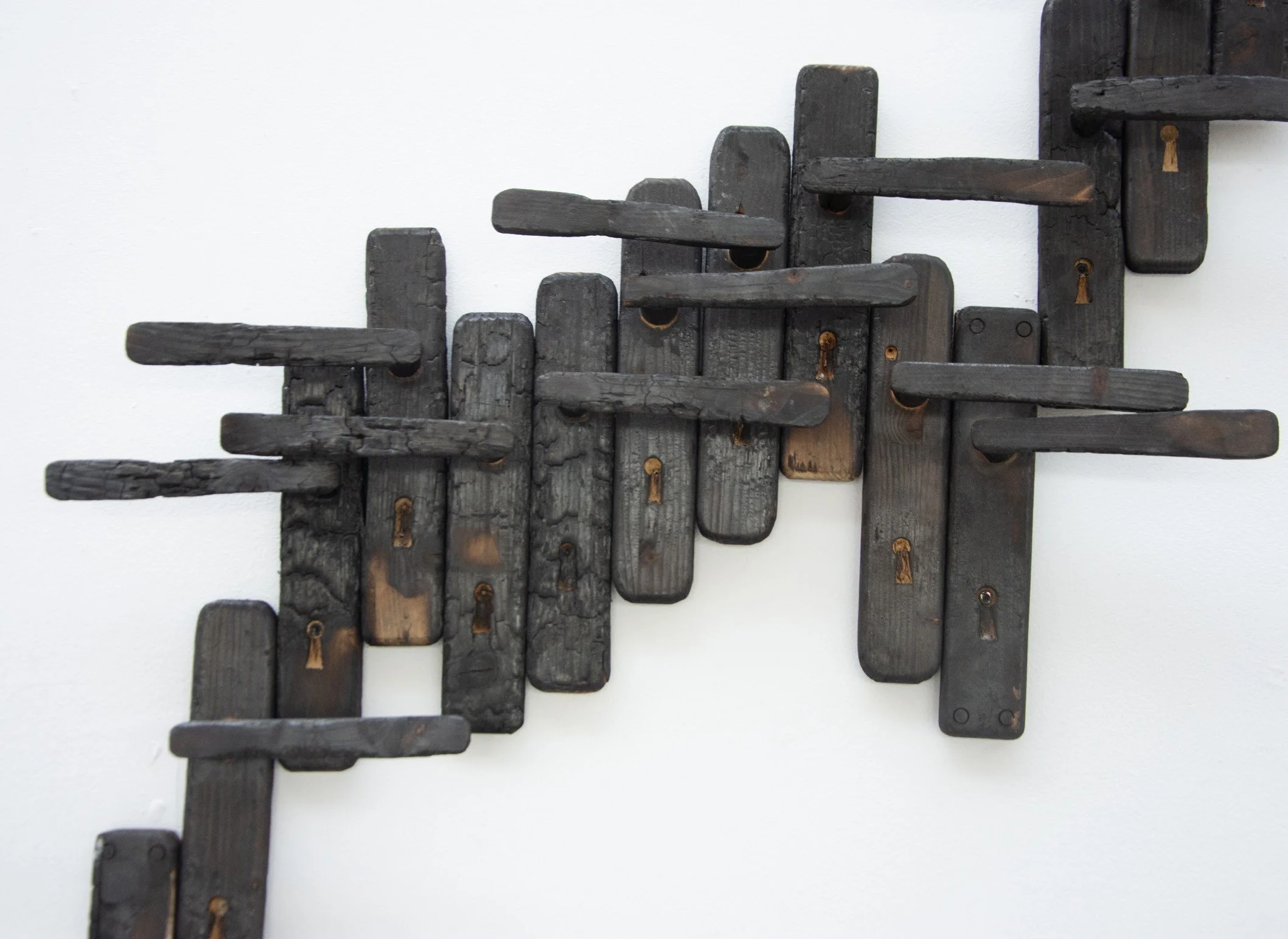 A Statistic of Trauma, 2023. Burnt door handles (detail).