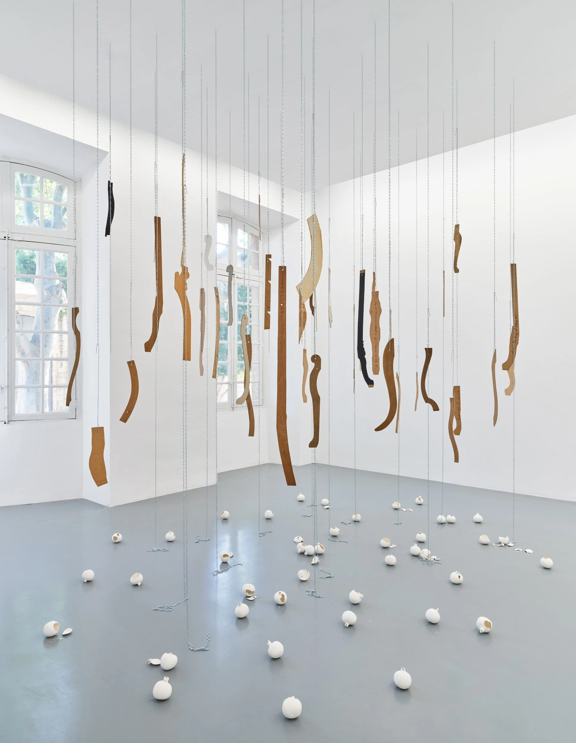 While Waiting for Your Return, 2026. Furniture templates, plaster pomegranates, chains.