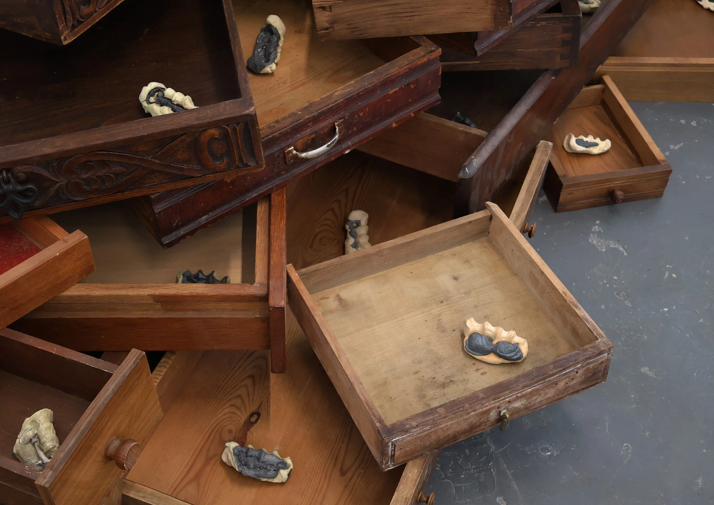 Missing You Is a Rock I Carry, 2025. Drawers, melted keys, ceramic.