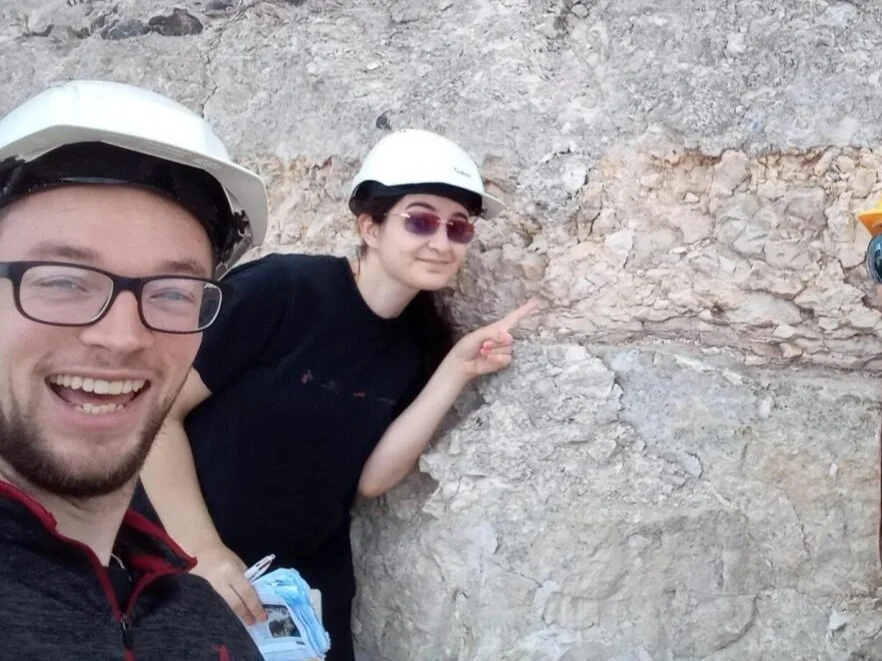 Two scientists at the K-Pg boundary at Stevns Klint