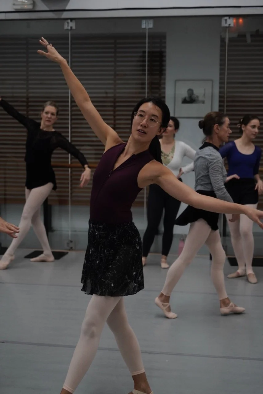 Ballet dancers practicing choreography in a Spanish dance studio.