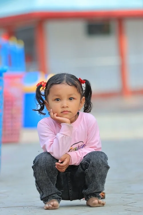 Little girl resting her chin in her hand.