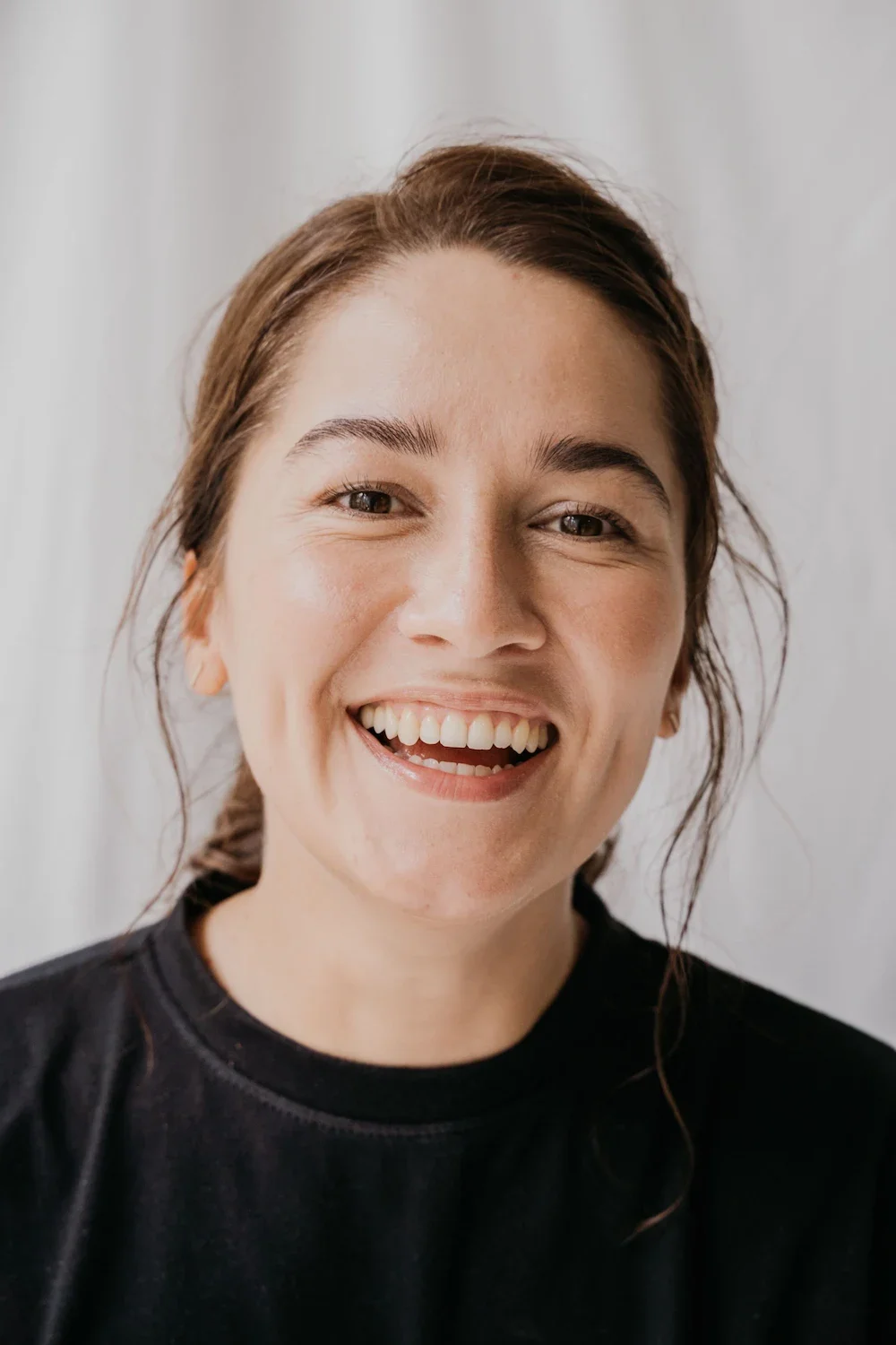 A portrait of a smiling woman.