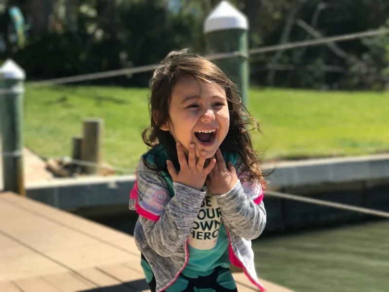A child laughing outside.