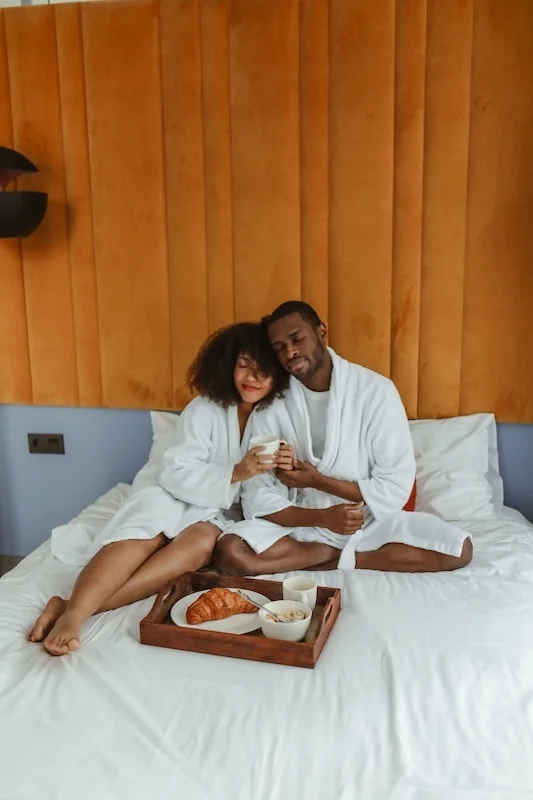 a happy couple in bed together.