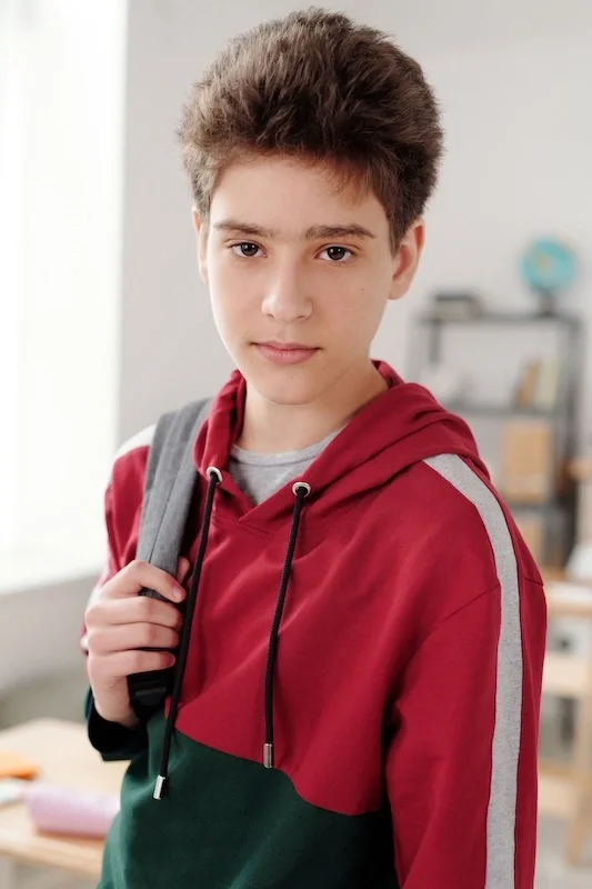 Teen boy with a red hoodie.