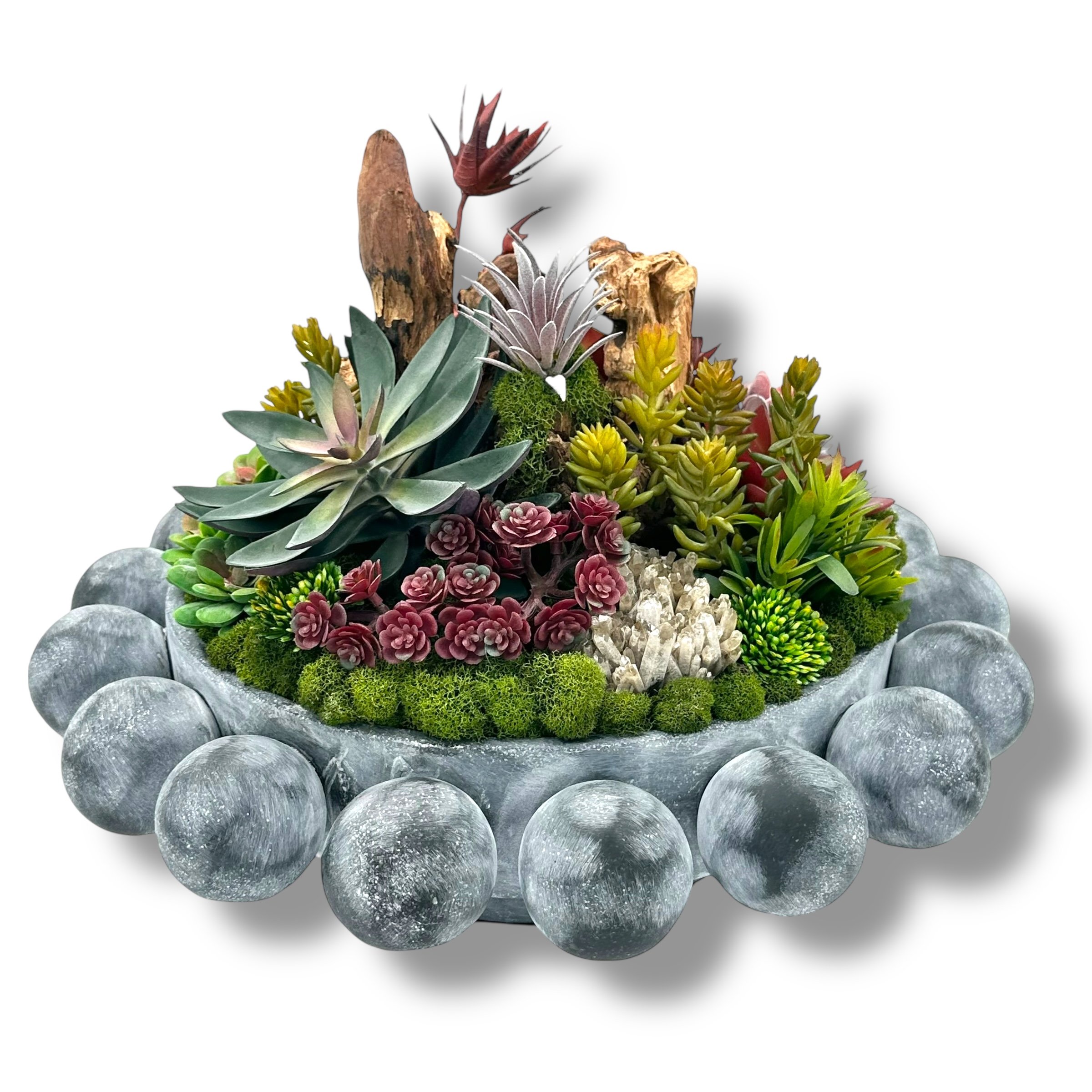 Arrangement of various succulents and rocks in a white container with a border of smooth grey stones.